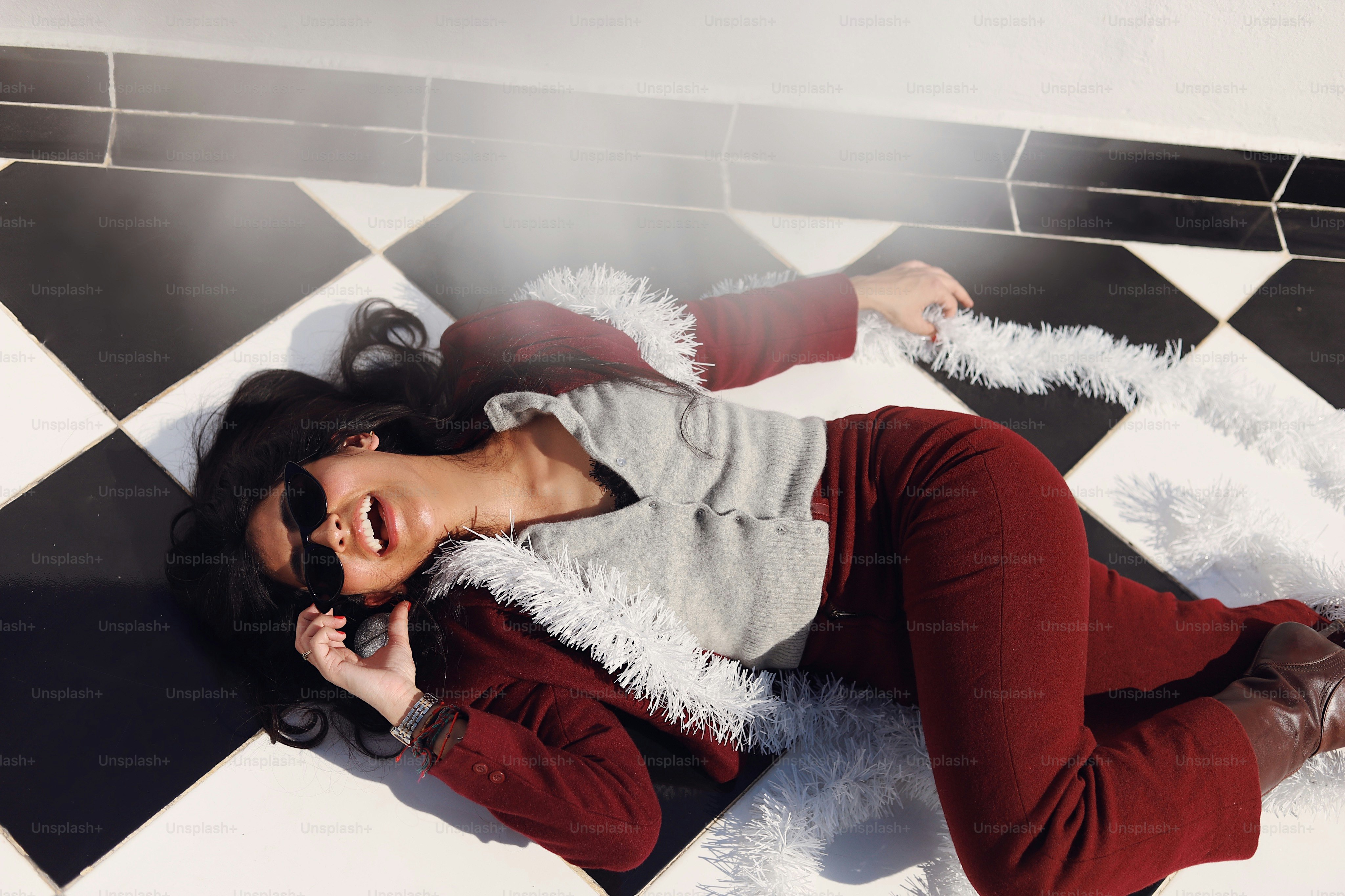 A woman laying on the floor talking on a cell phone