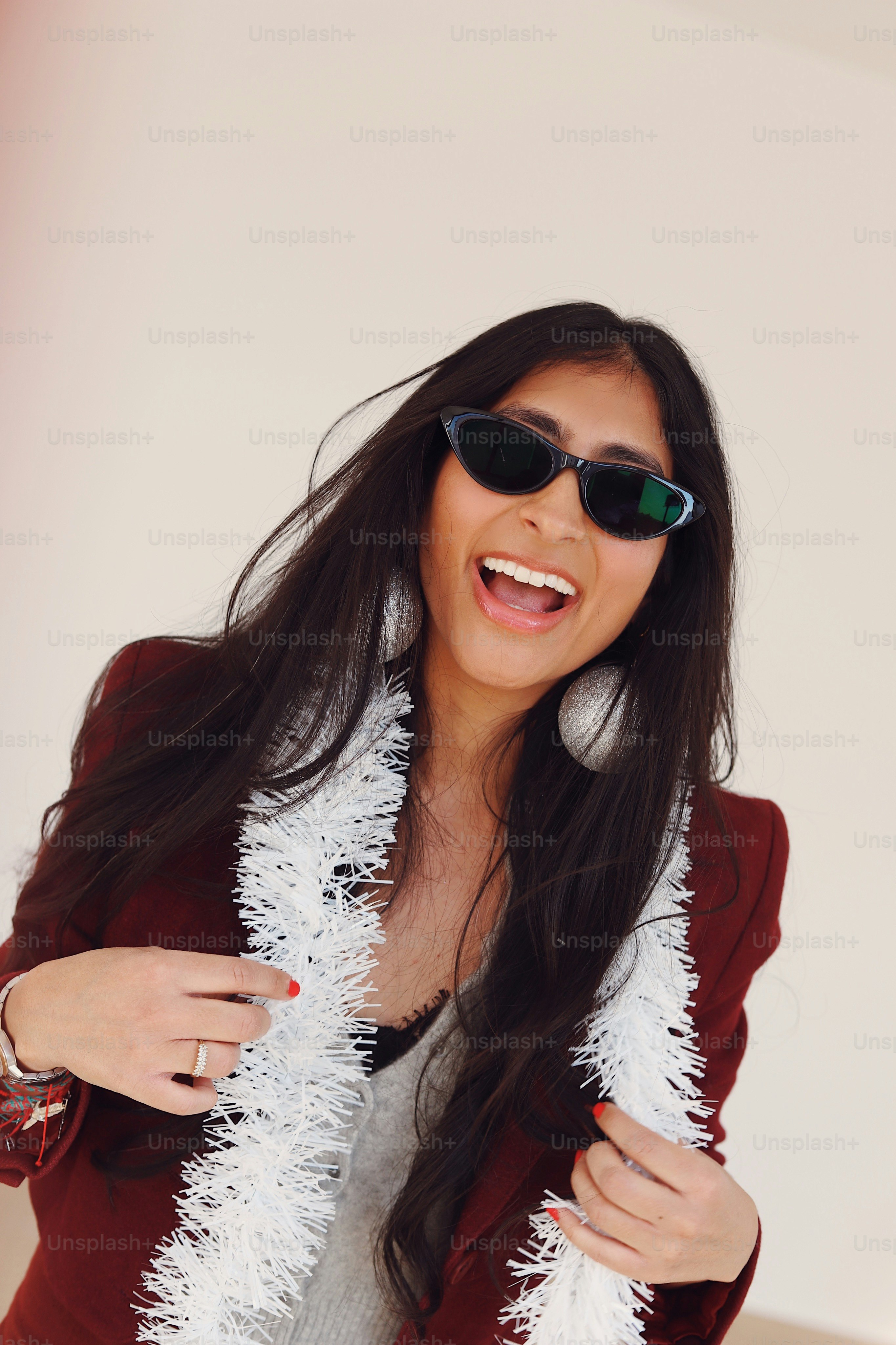 A woman wearing sunglasses and a red jacket