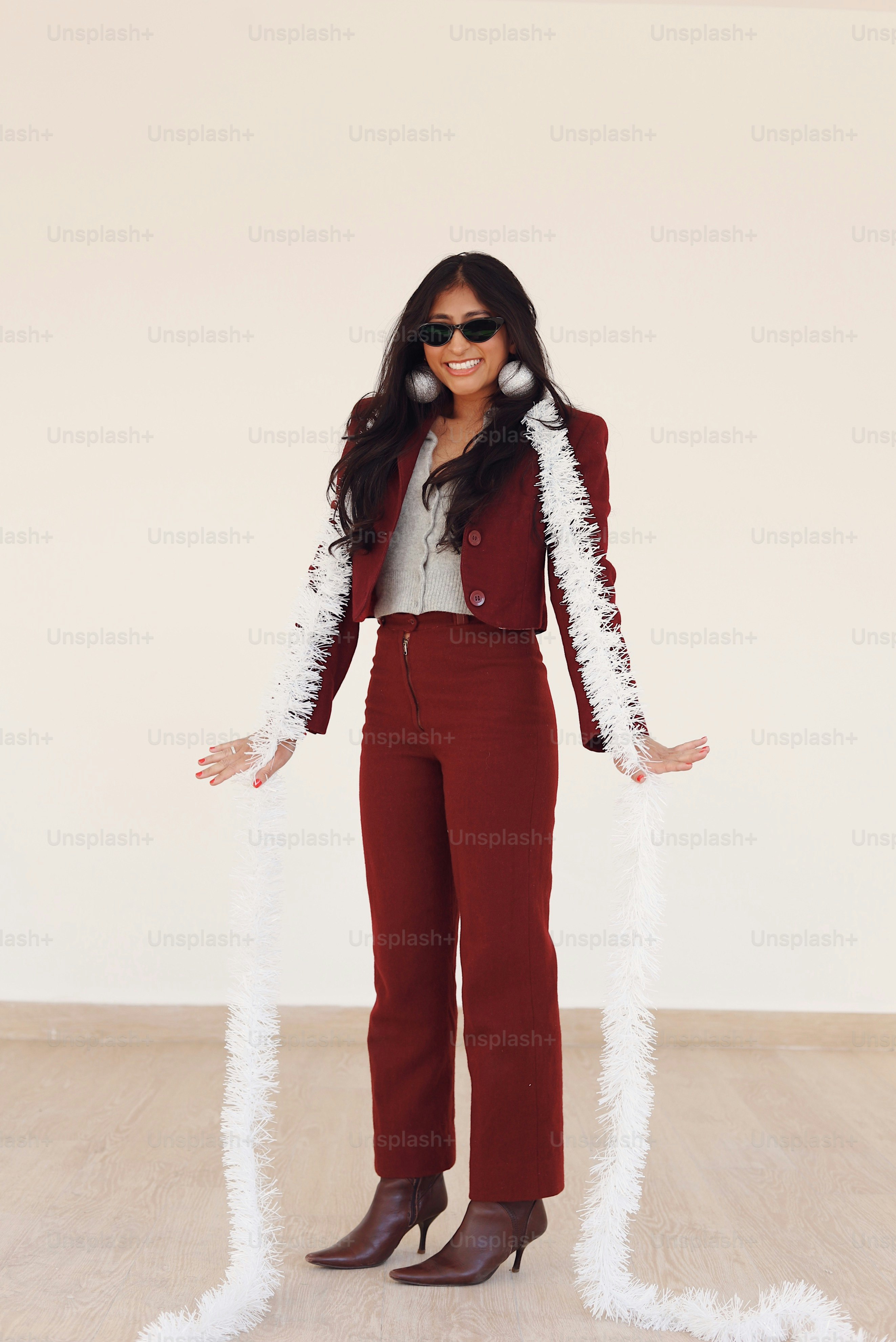 A woman standing in a room wearing a red suit