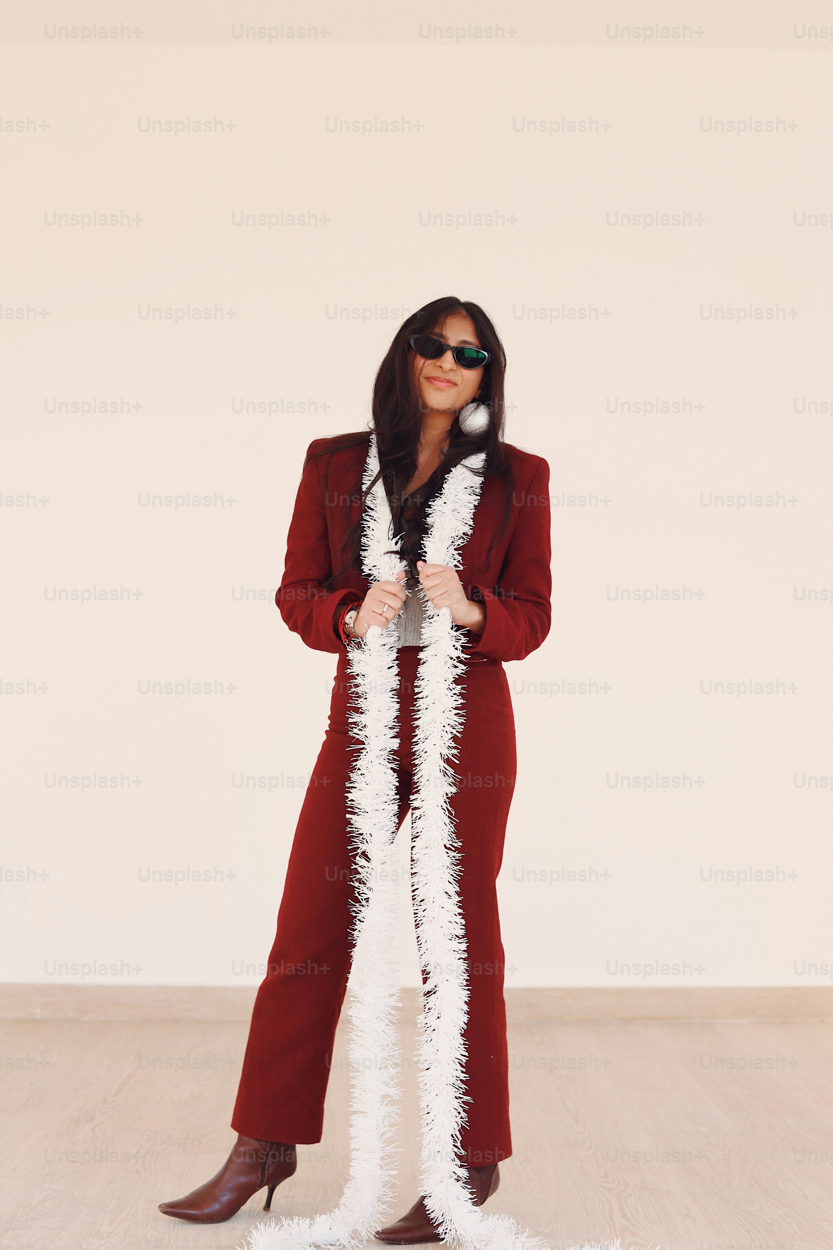 A woman in a red suit and white feather boa
