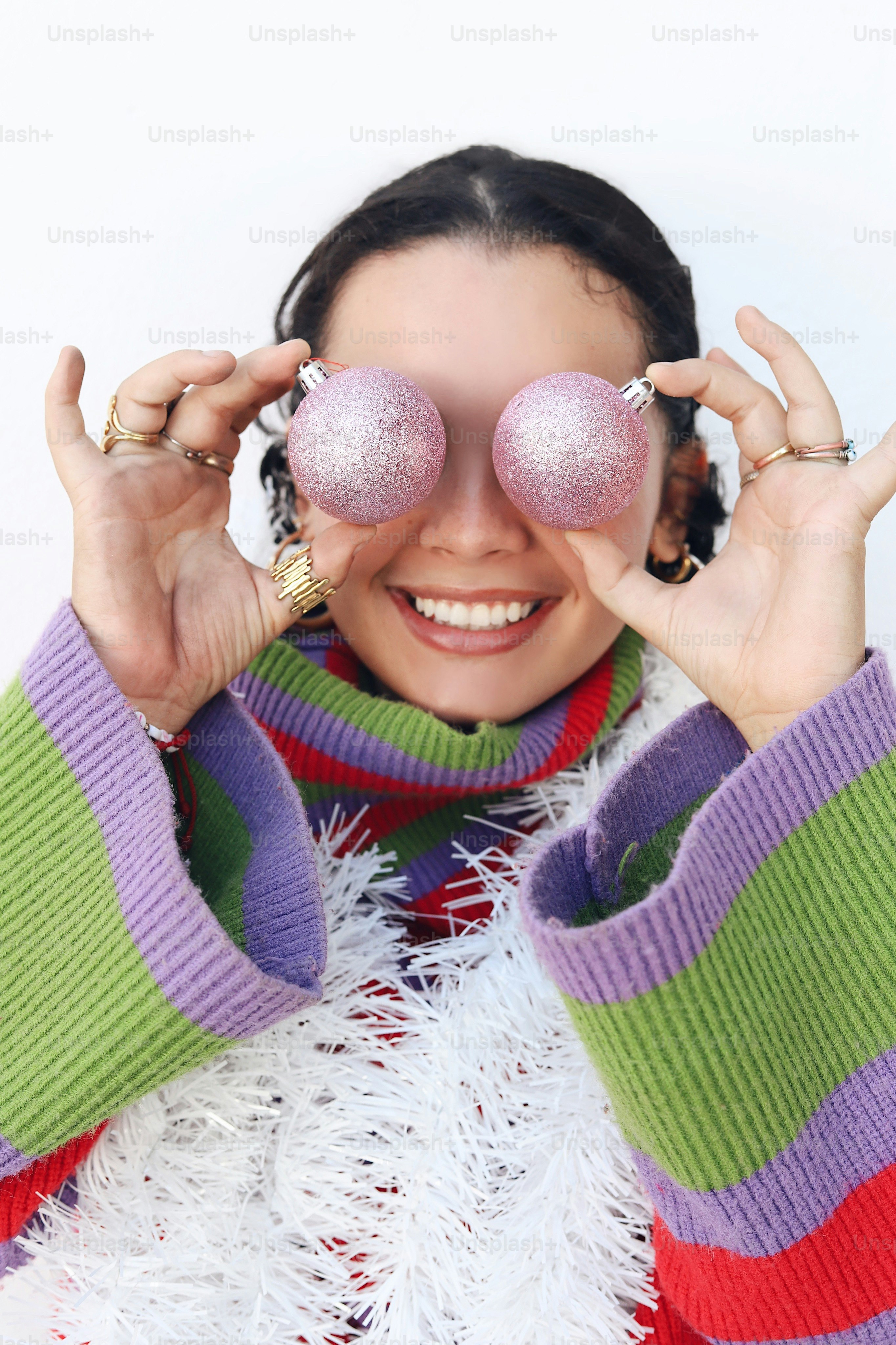 A woman holding two balls in front of her eyes