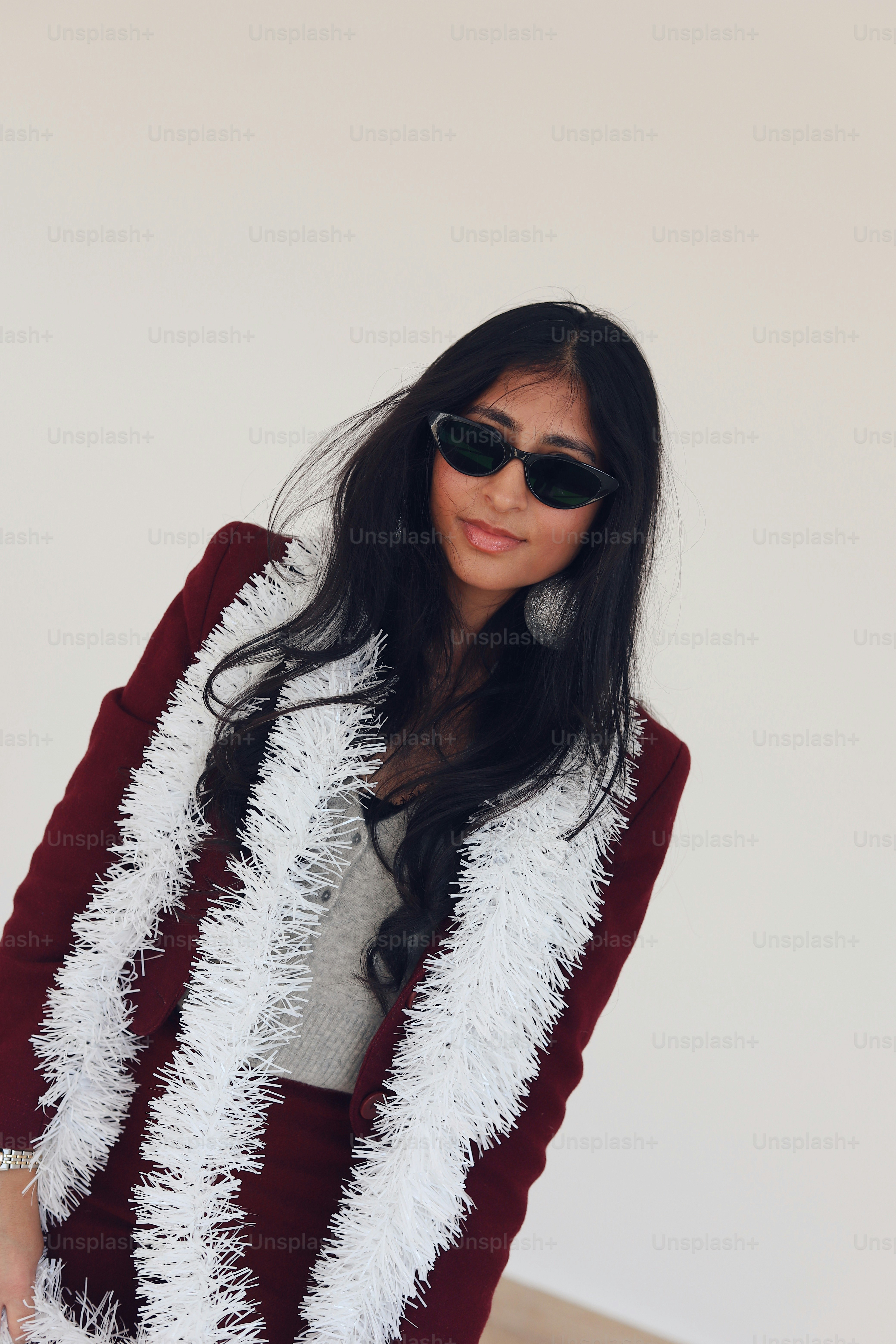 A woman wearing a red and white fuzzy coat