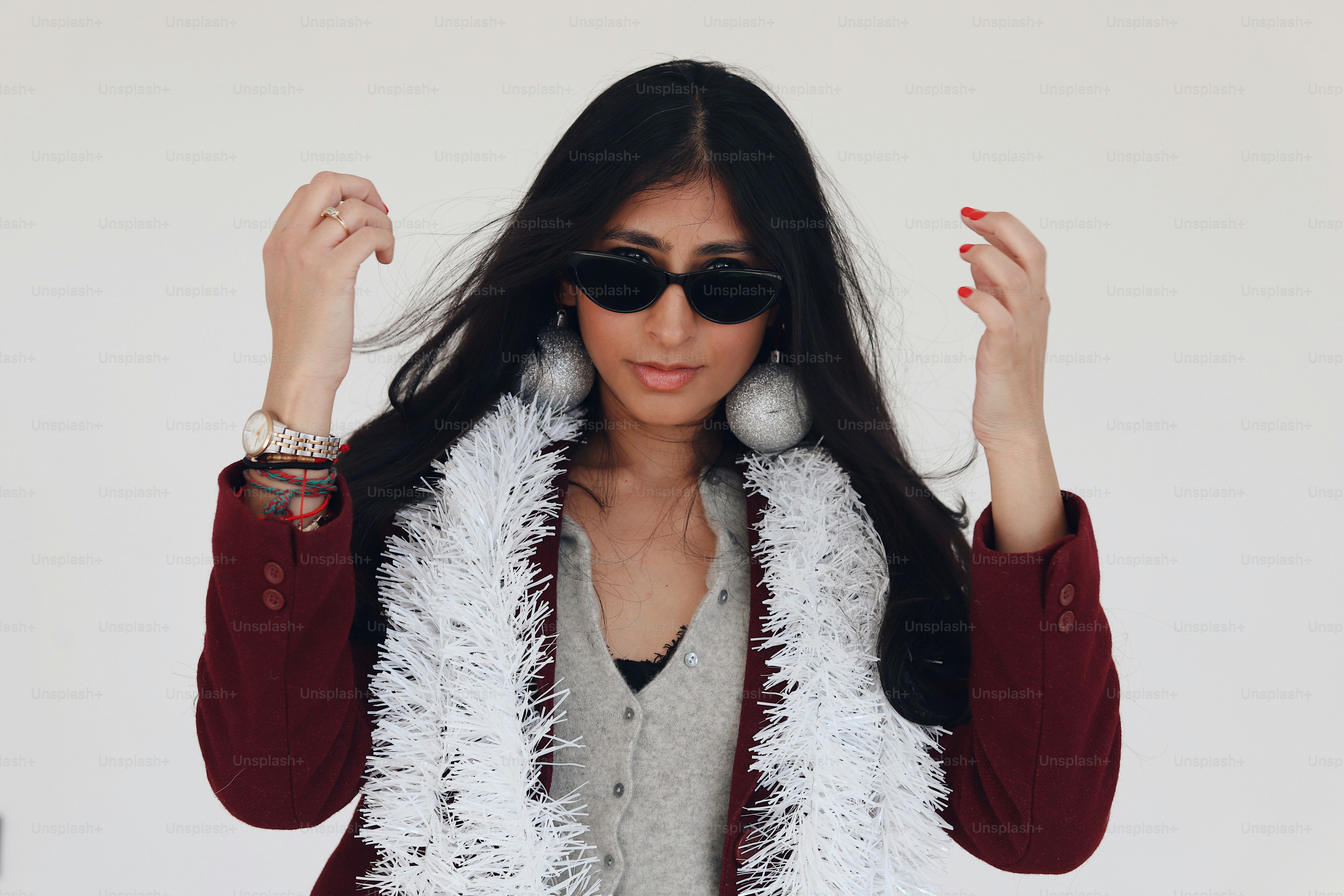 A woman wearing sunglasses and a fur vest