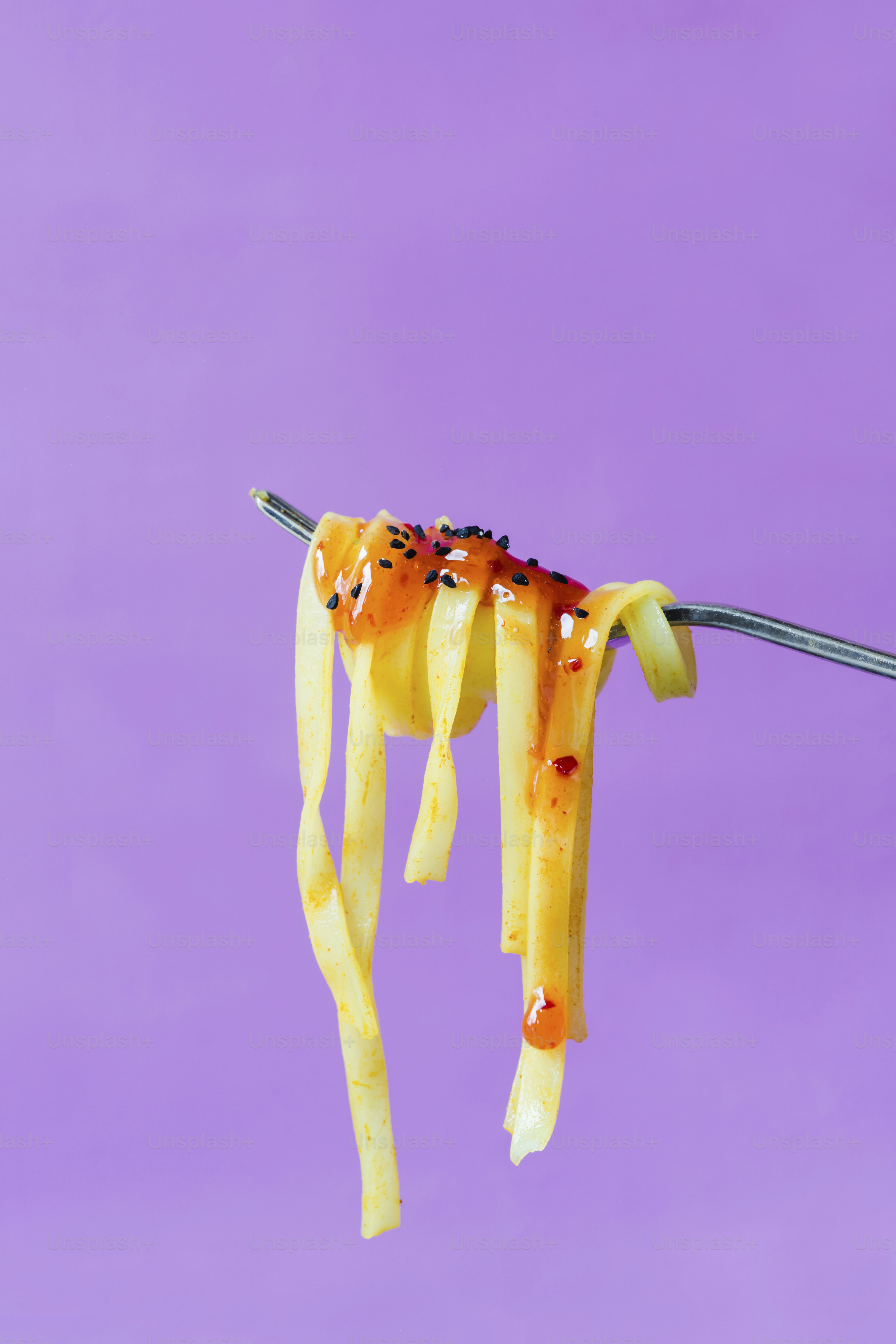 A fork with some food hanging from it