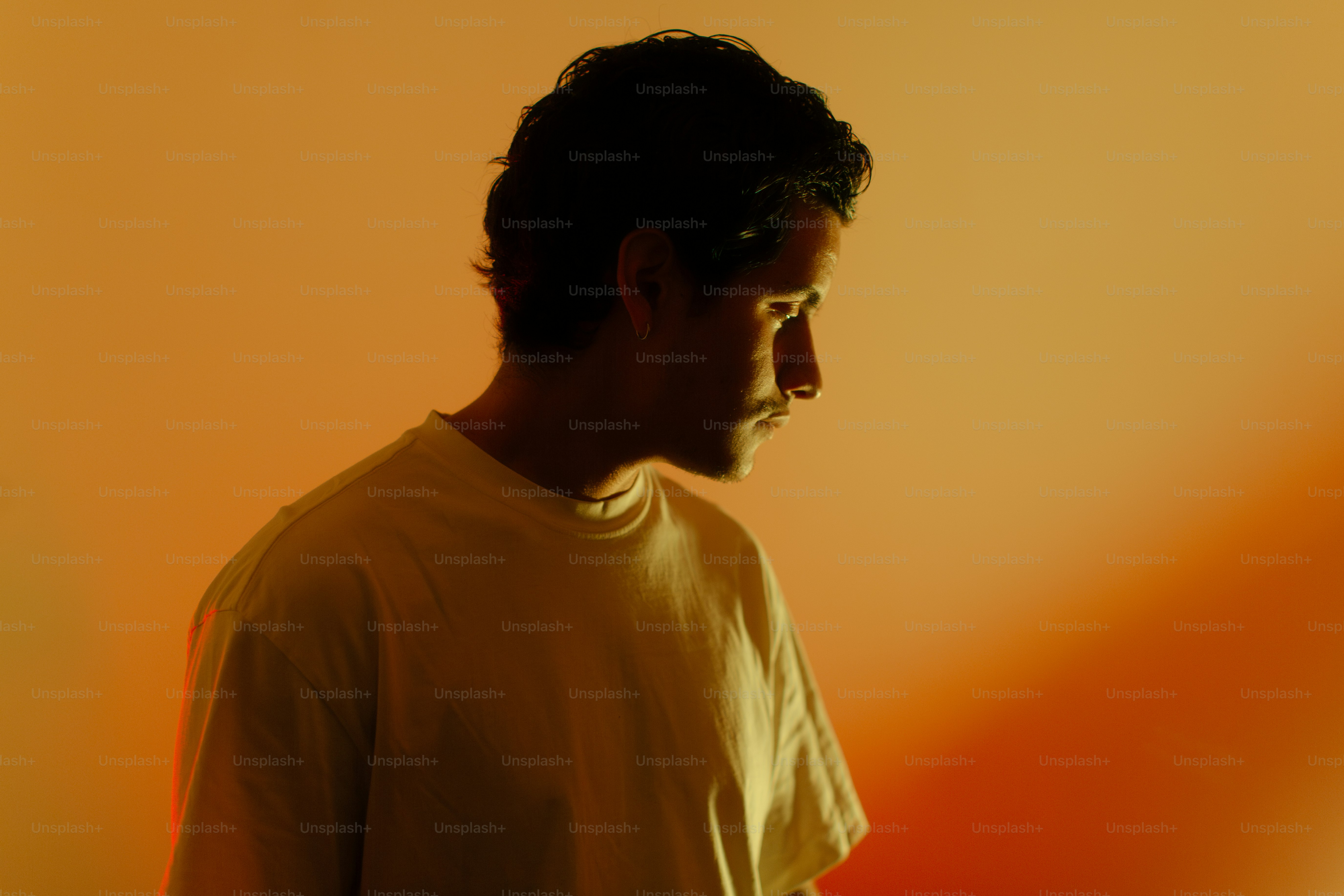 A man standing in front of a yellow wall photo – Portrait Image on Unsplash