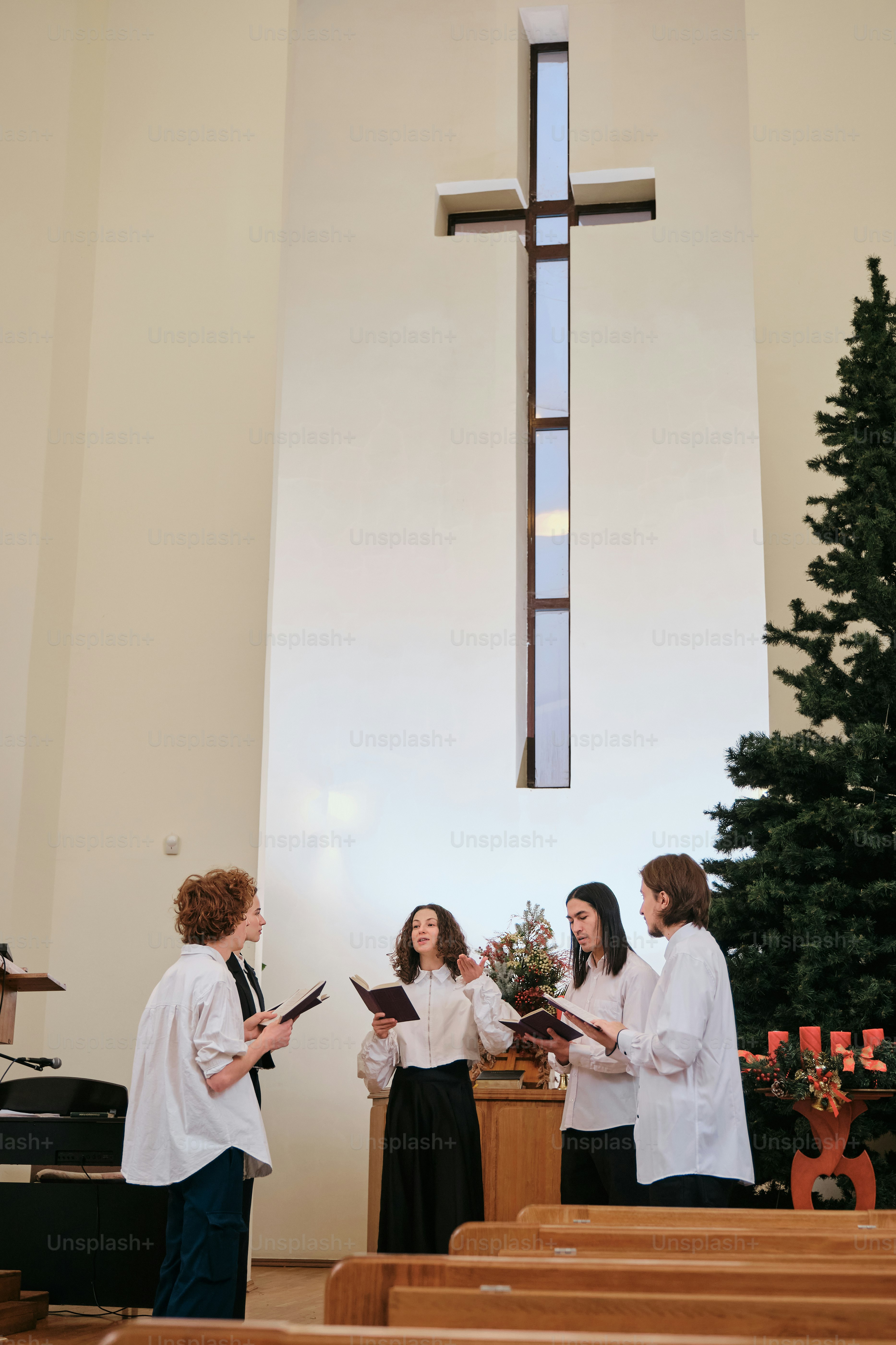 A group of people standing in front of a cross