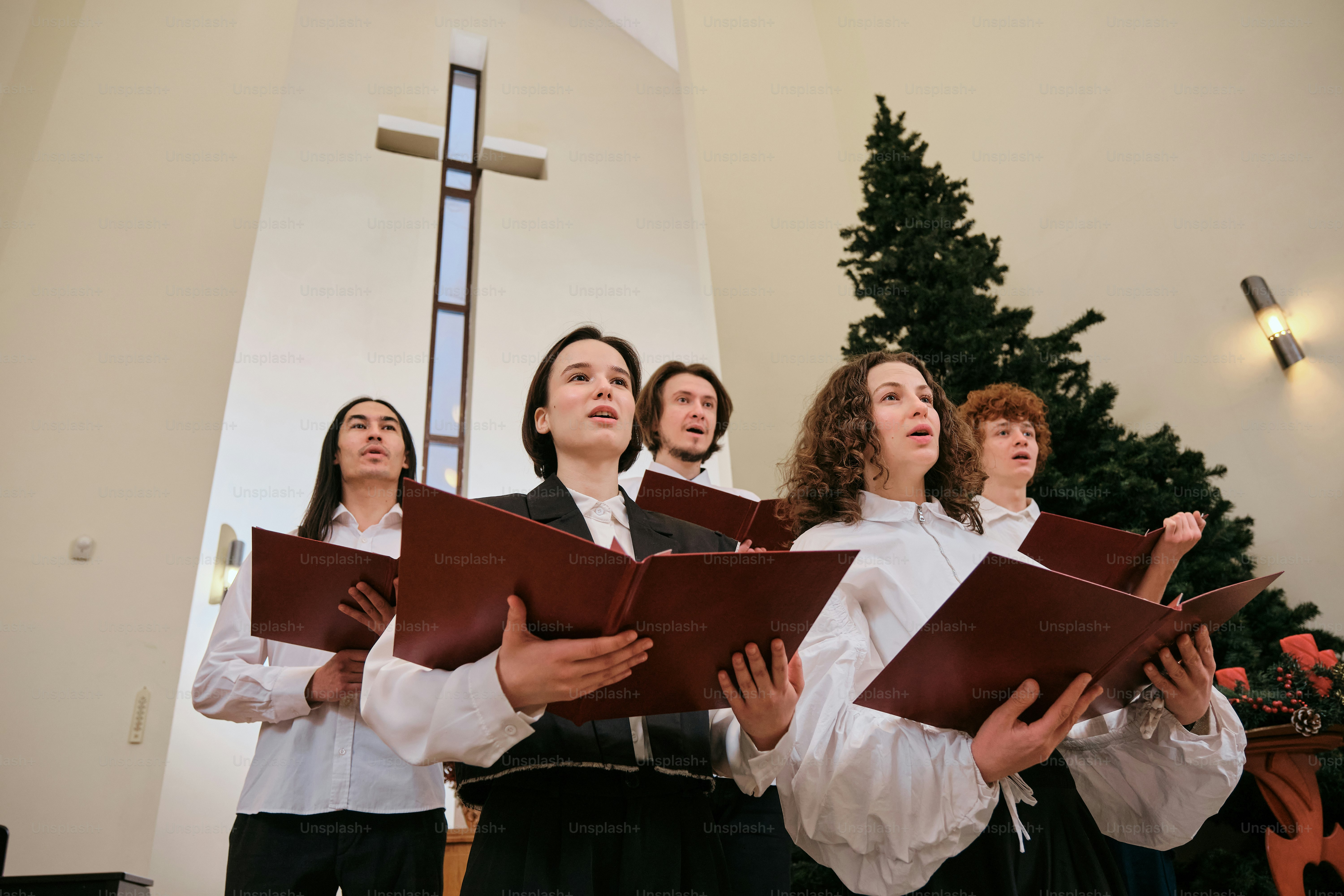 Um grupo de pessoas em frente a uma árvore de Natal