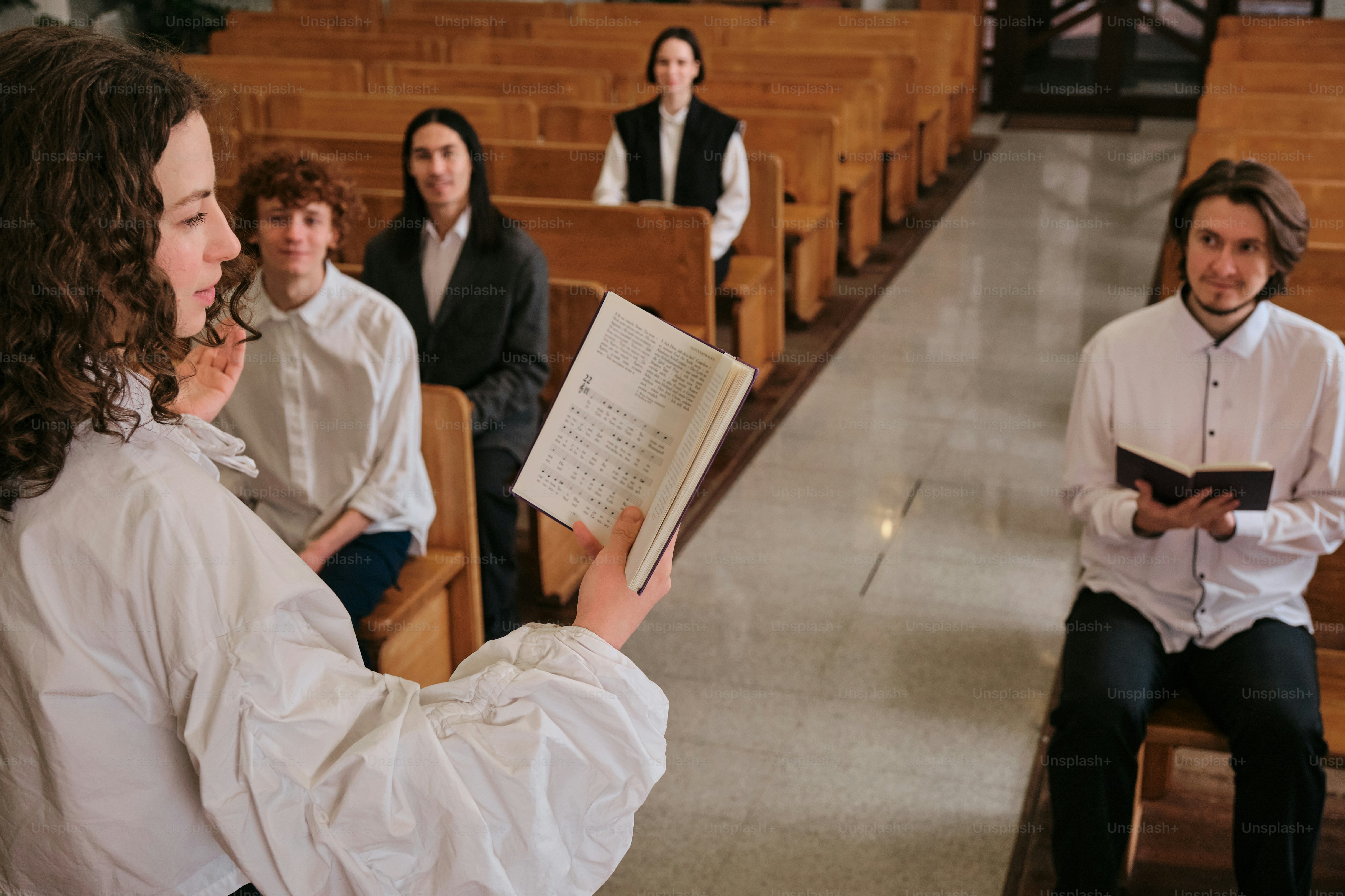 A group of people sitting in pews in a church