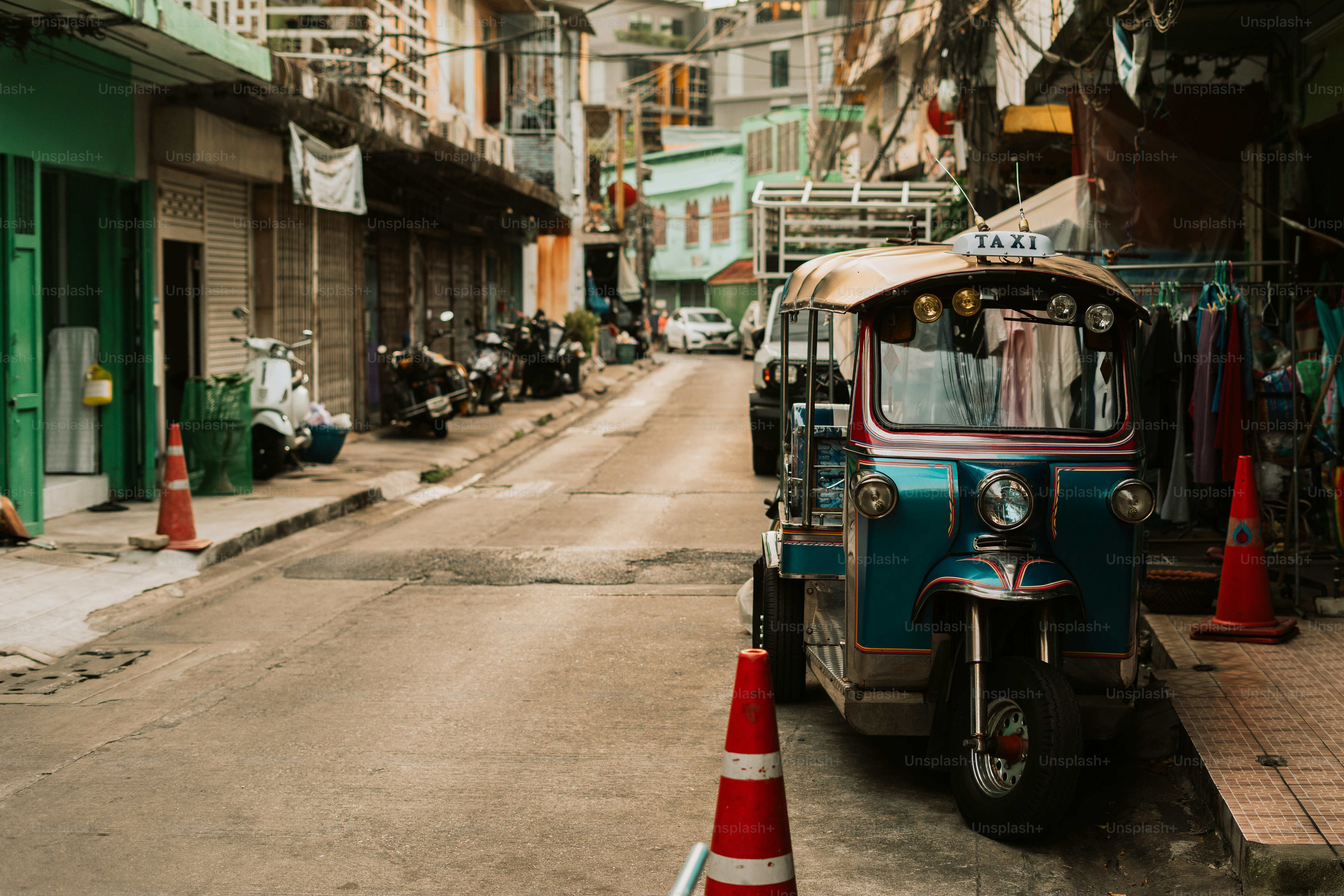 A tuk tuk parked on the side of a street