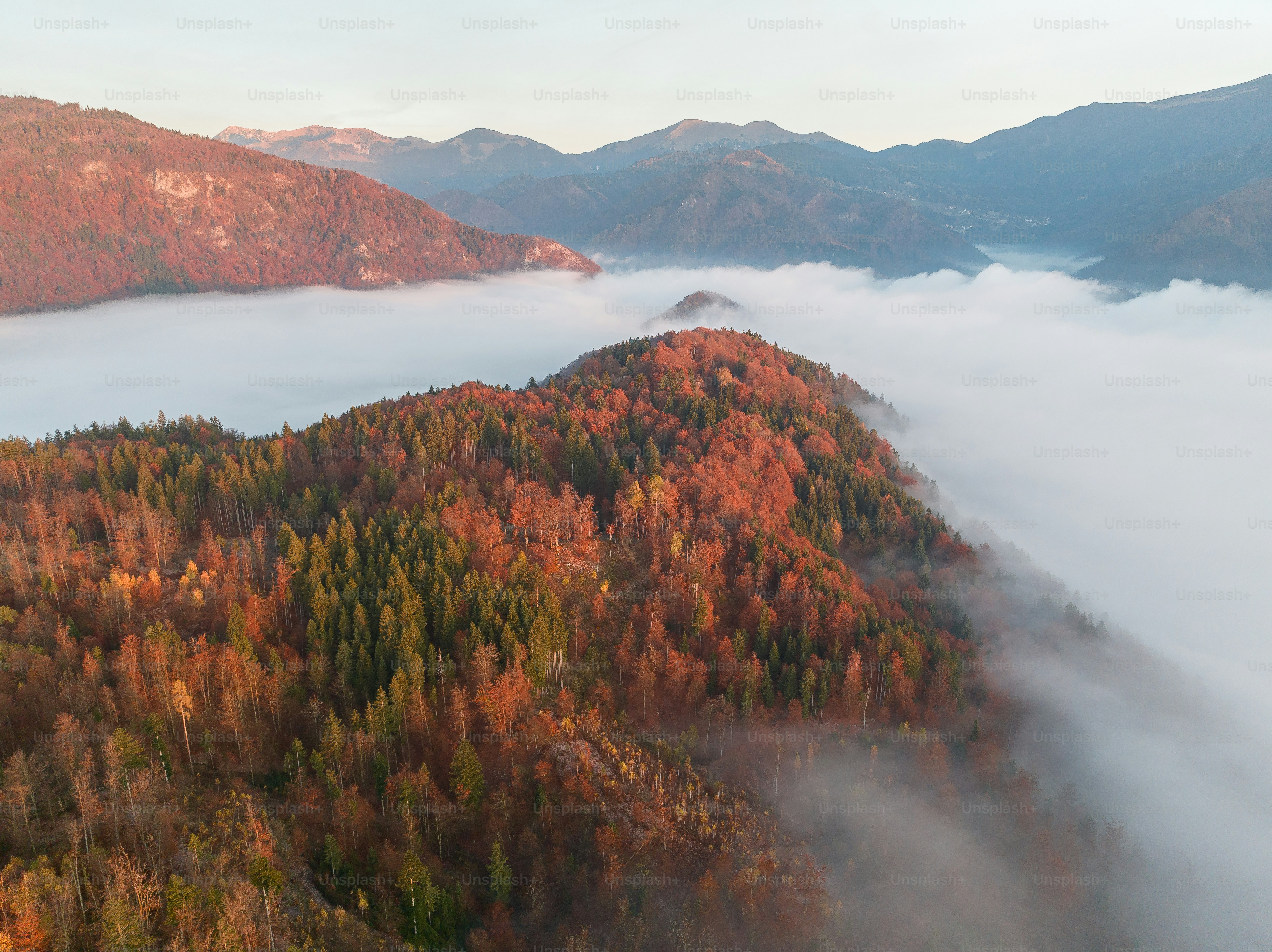 A view of a mountain covered in low lying clouds