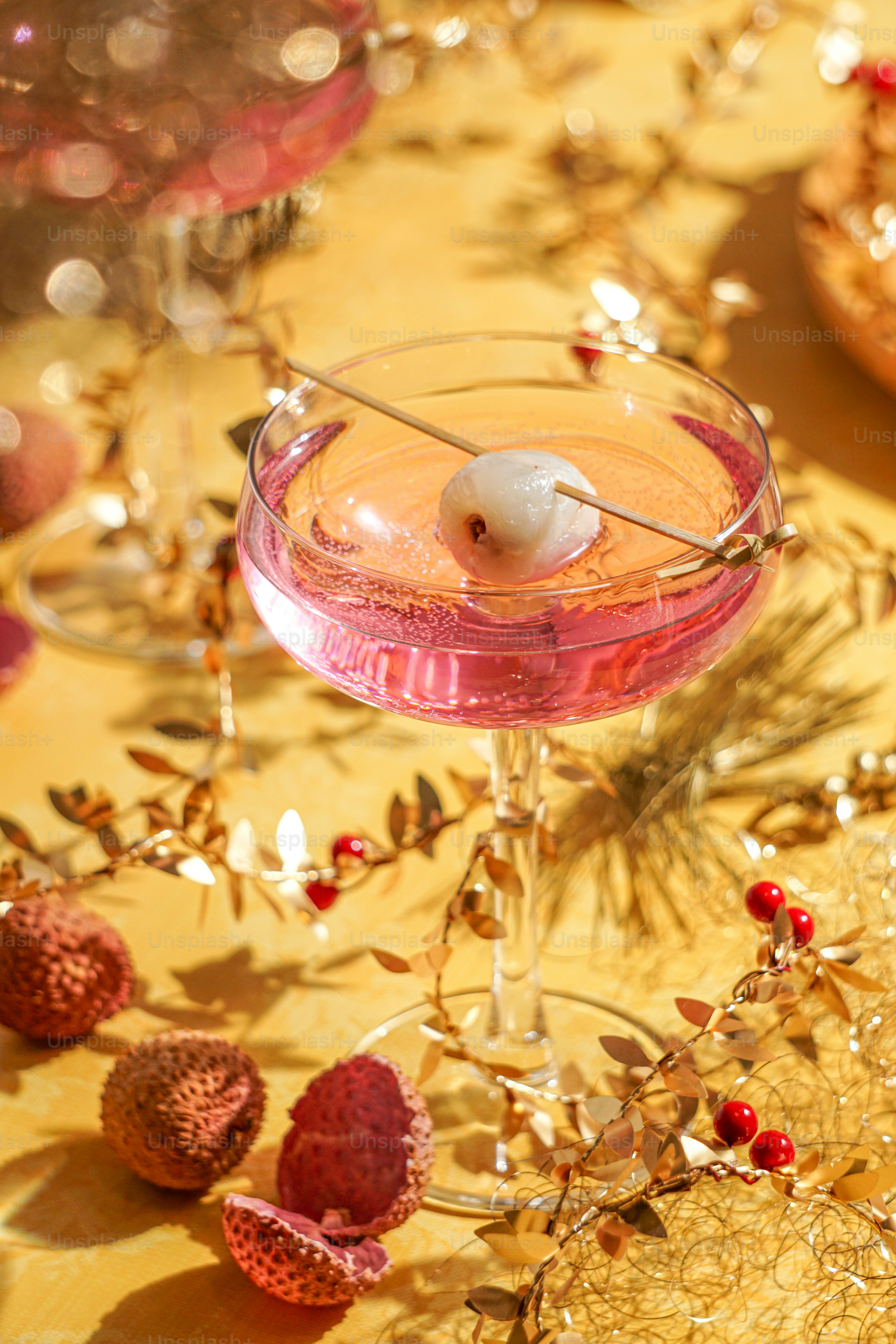 A table topped with a pink drink and desserts