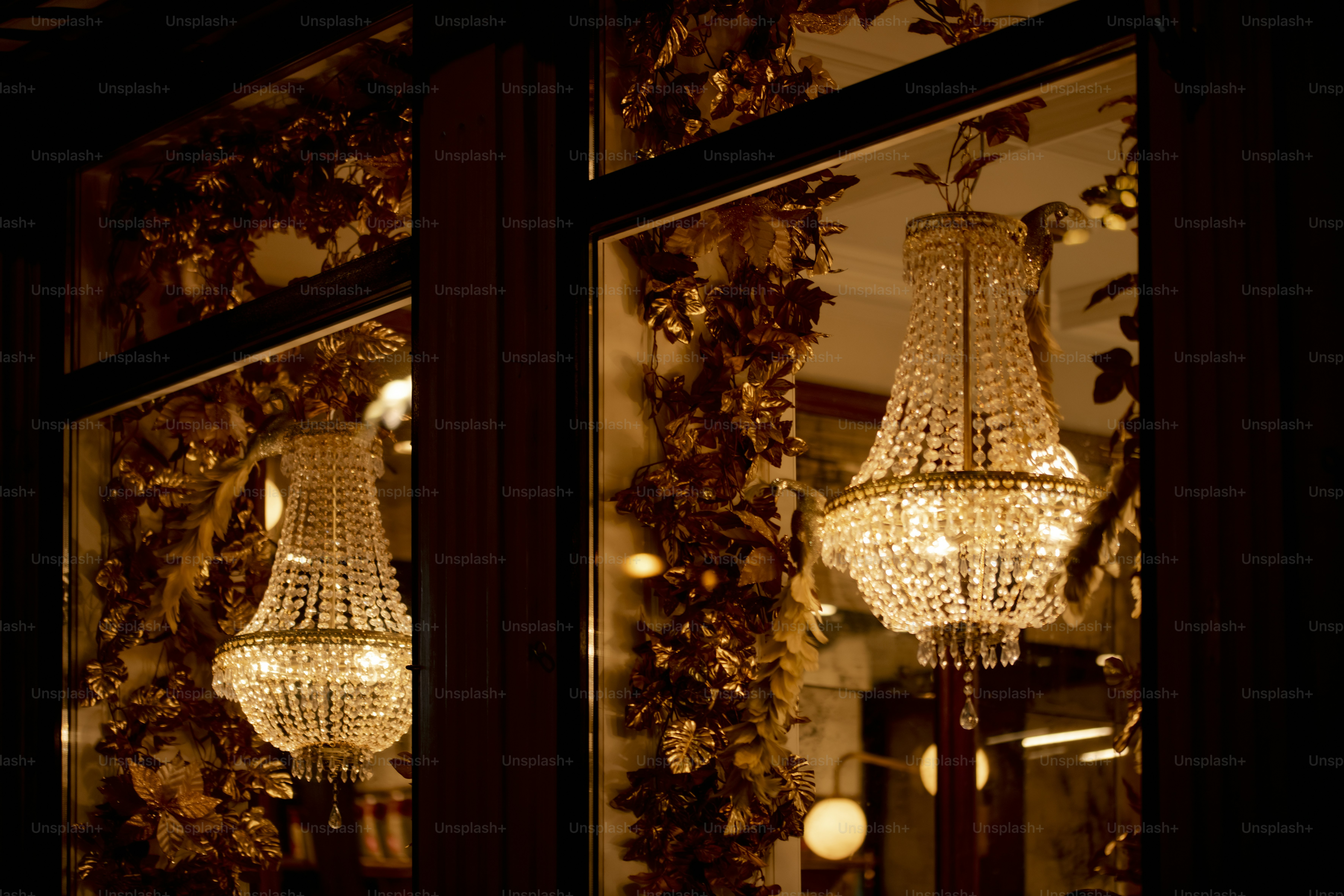A chandelier hanging in a window of a store