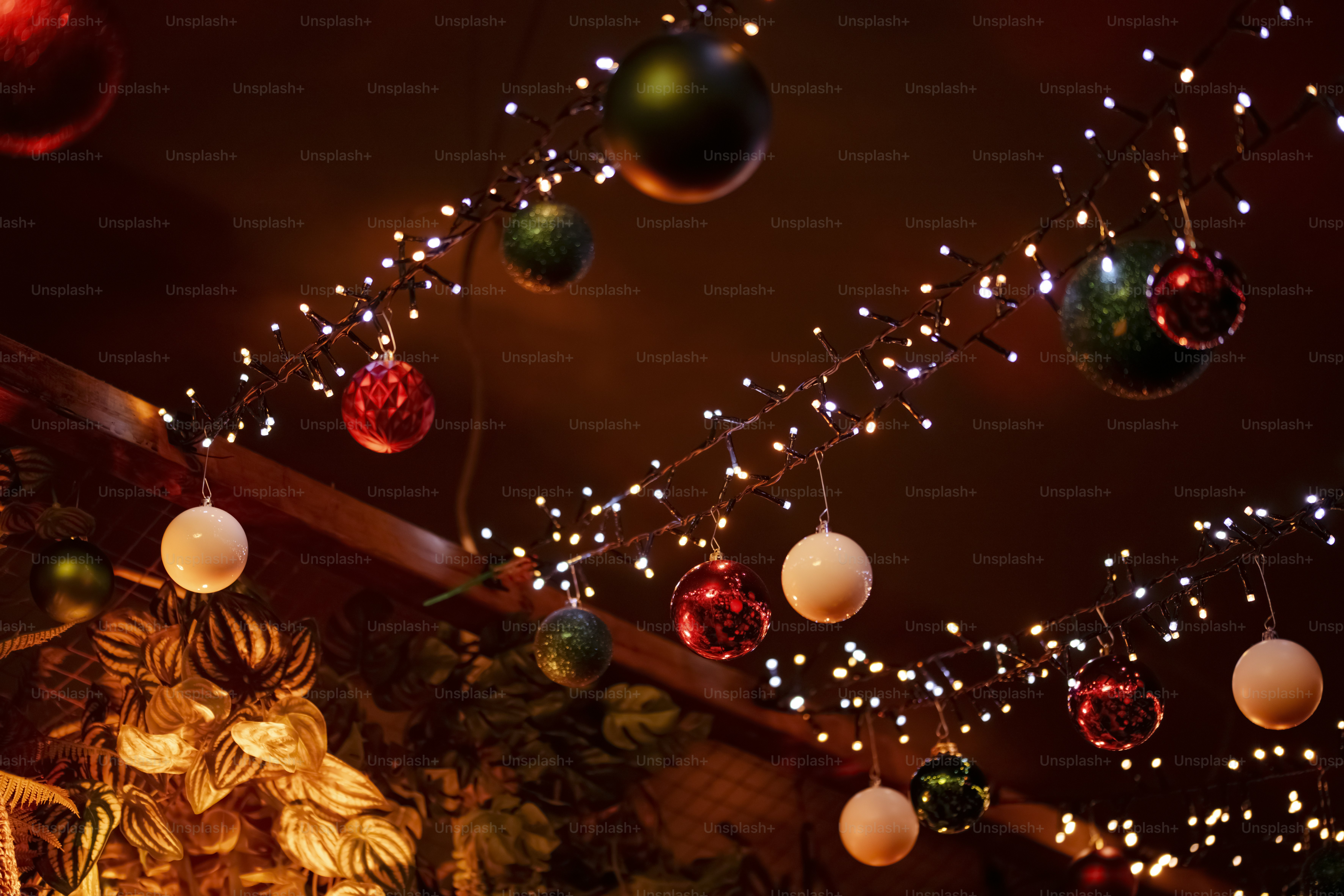 A group of christmas ornaments hanging from a ceiling