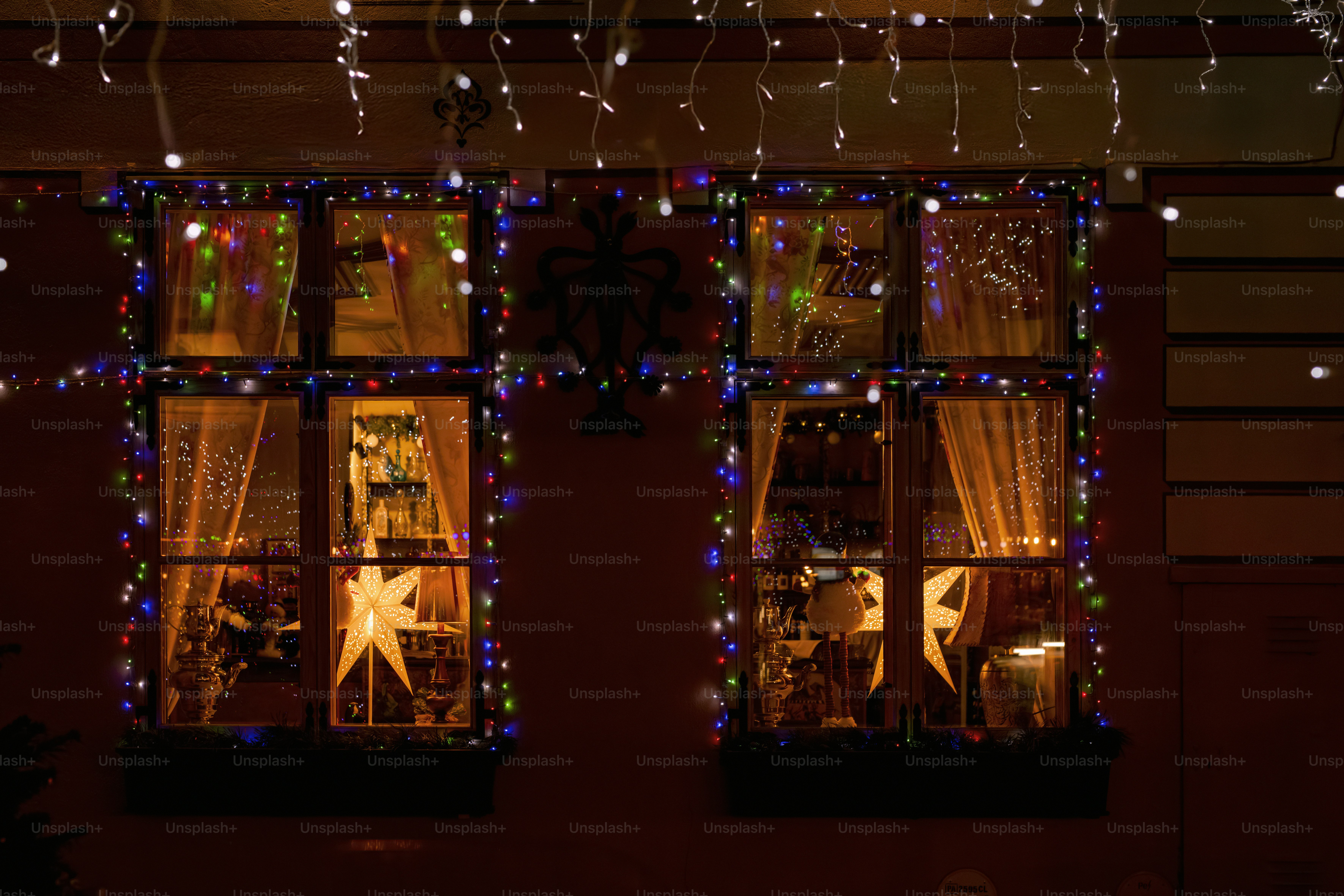 A couple of windows covered in christmas lights