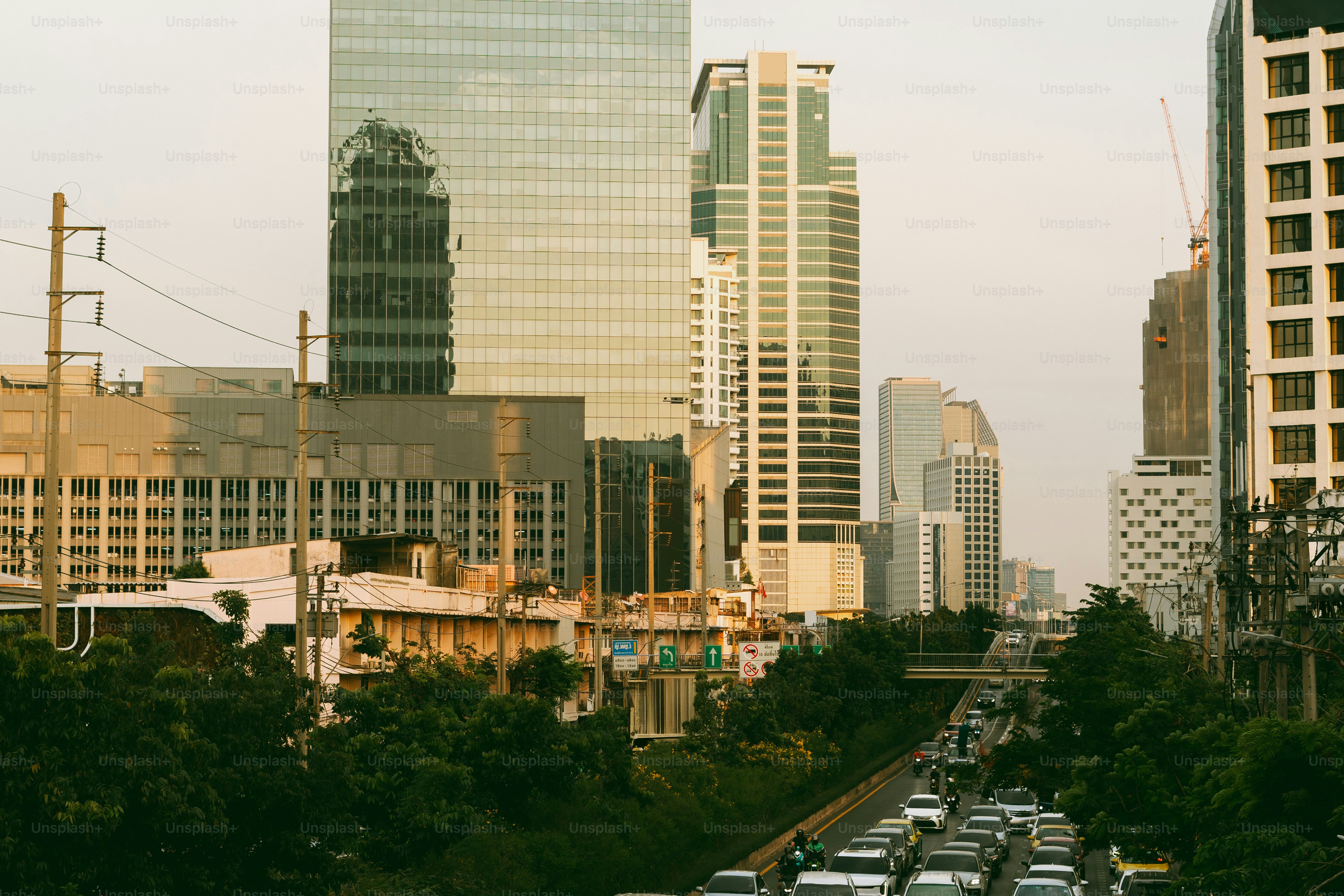 A city street filled with lots of traffic next to tall buildings