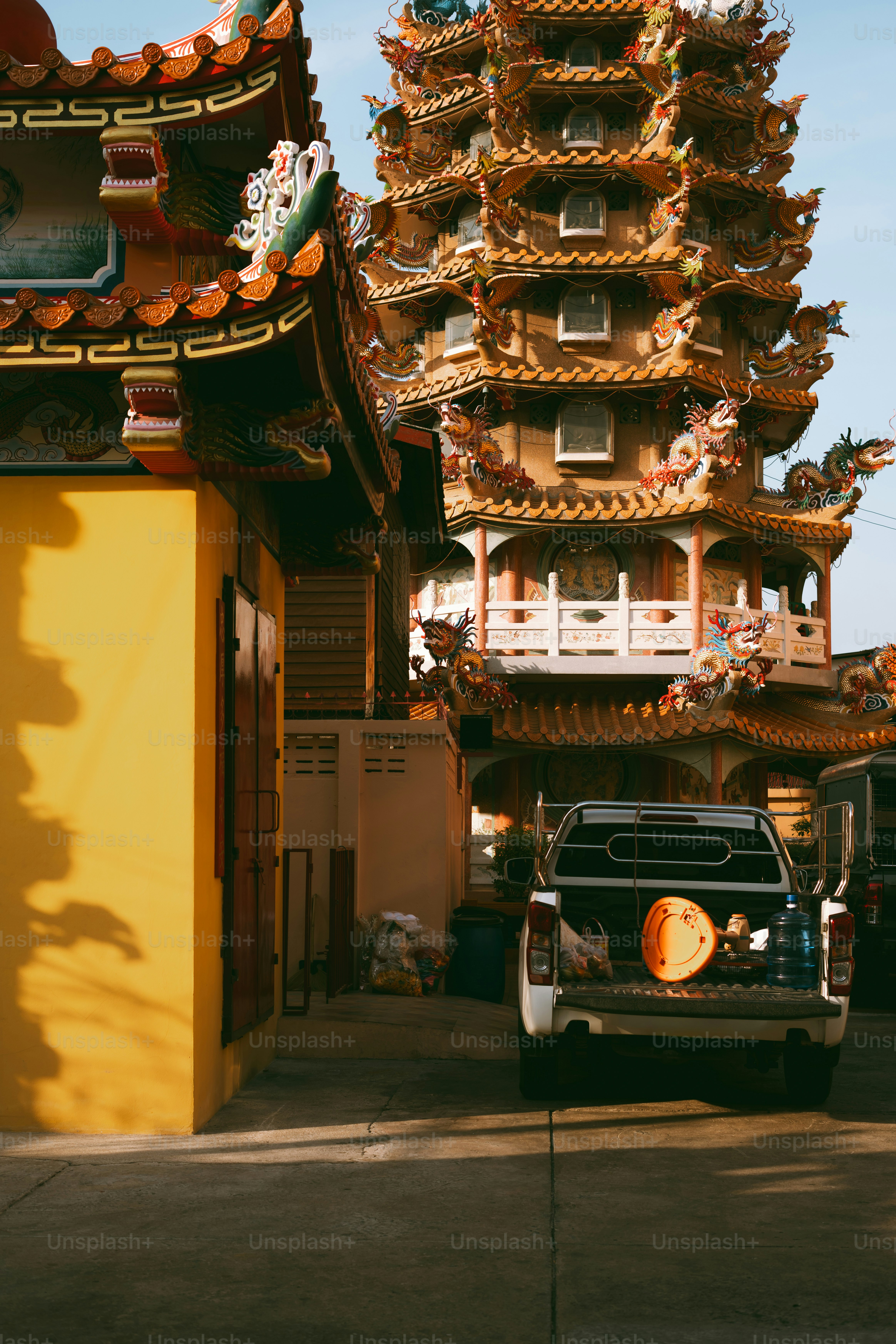 A truck parked in front of a tall building