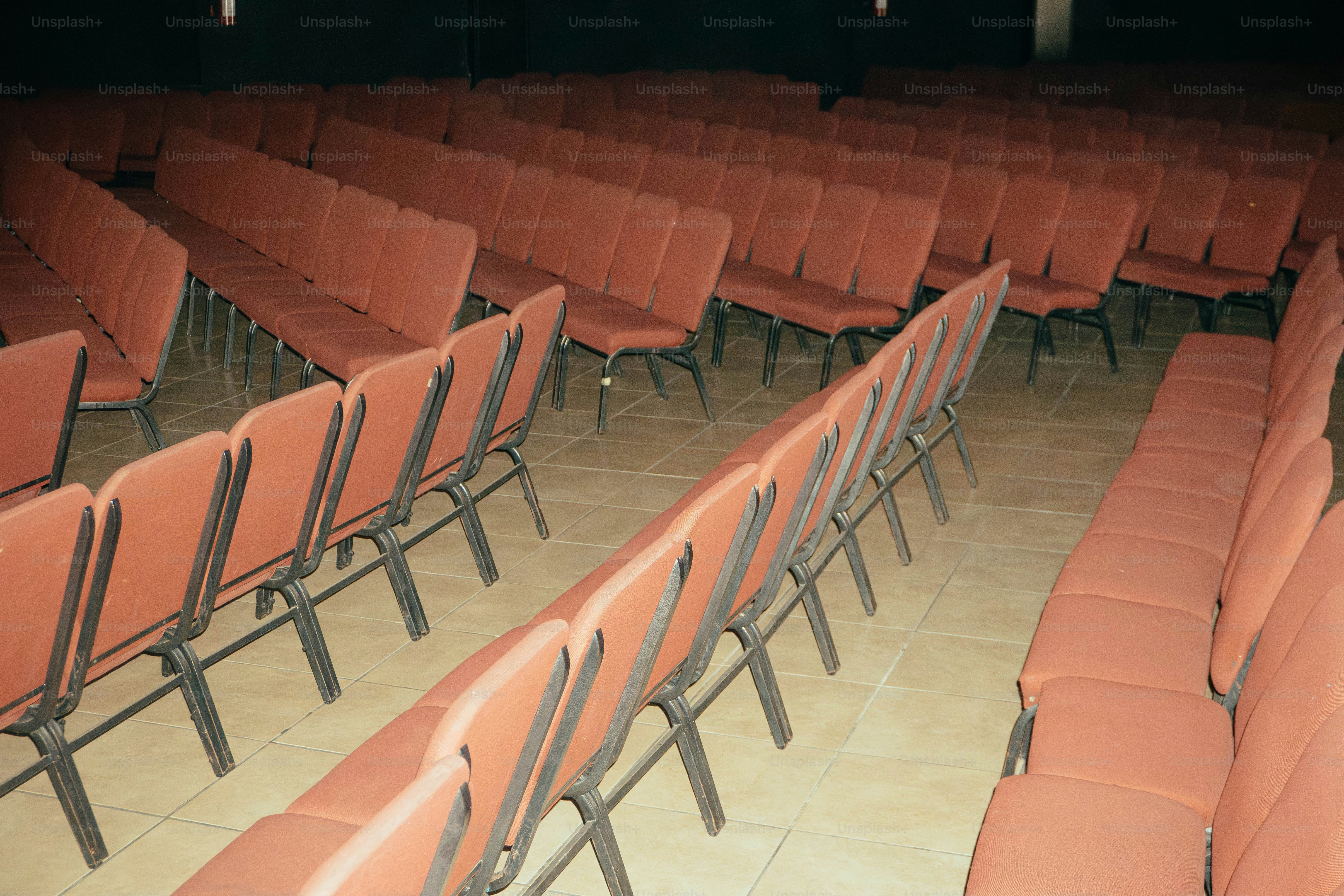 Rows of orange chairs in a large room