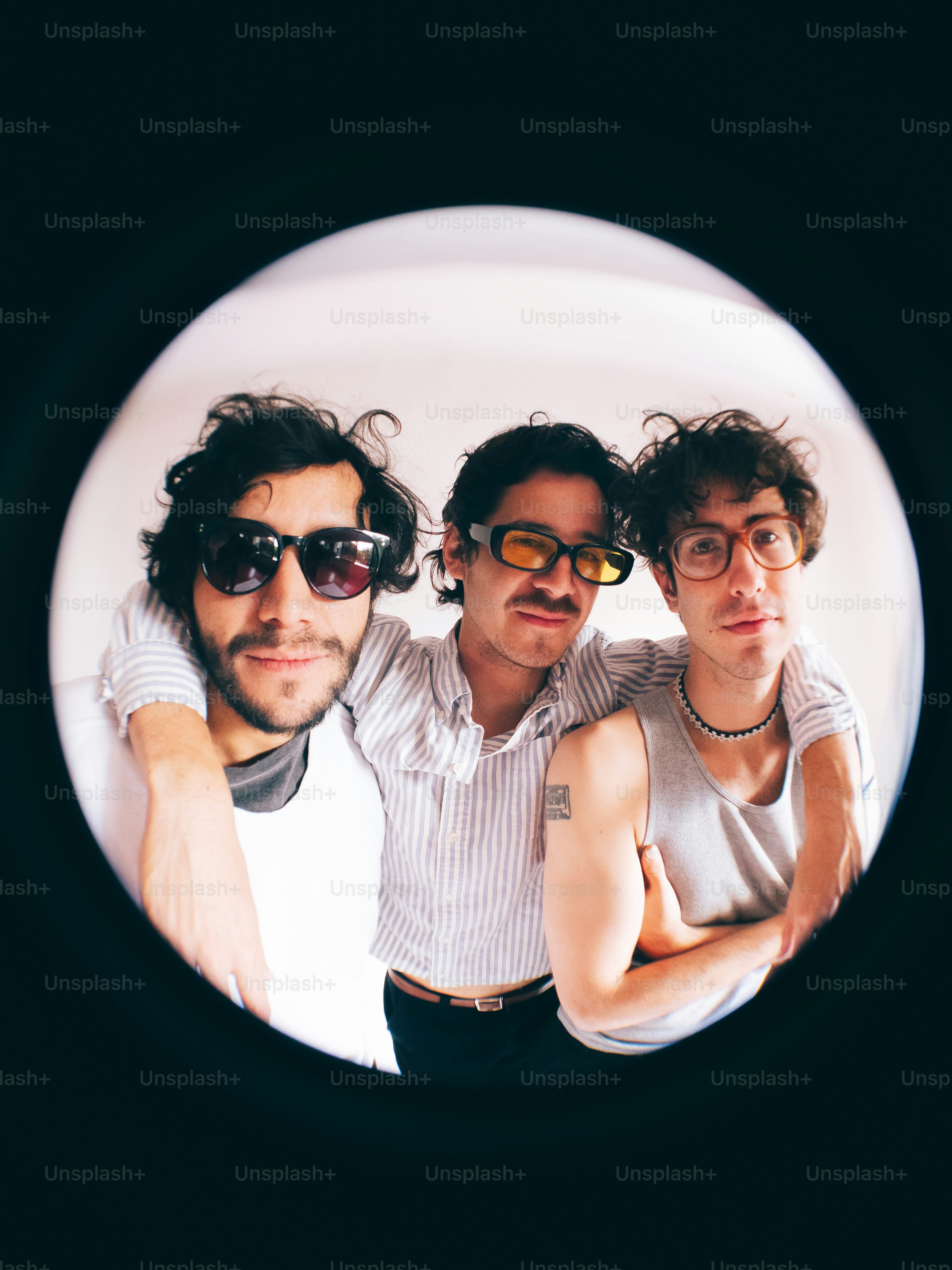 A group of three men standing next to each other