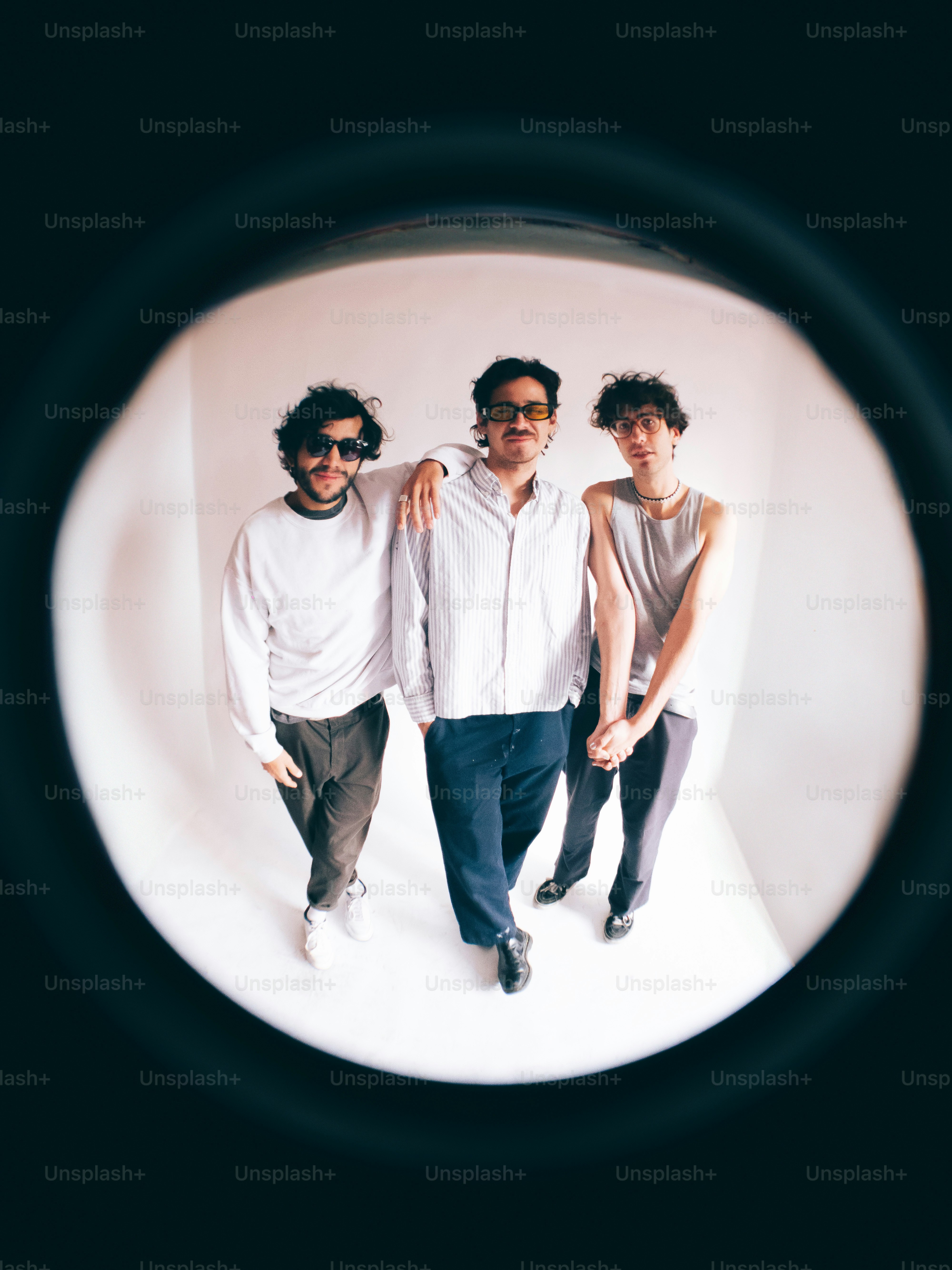 A group of three men standing next to each other