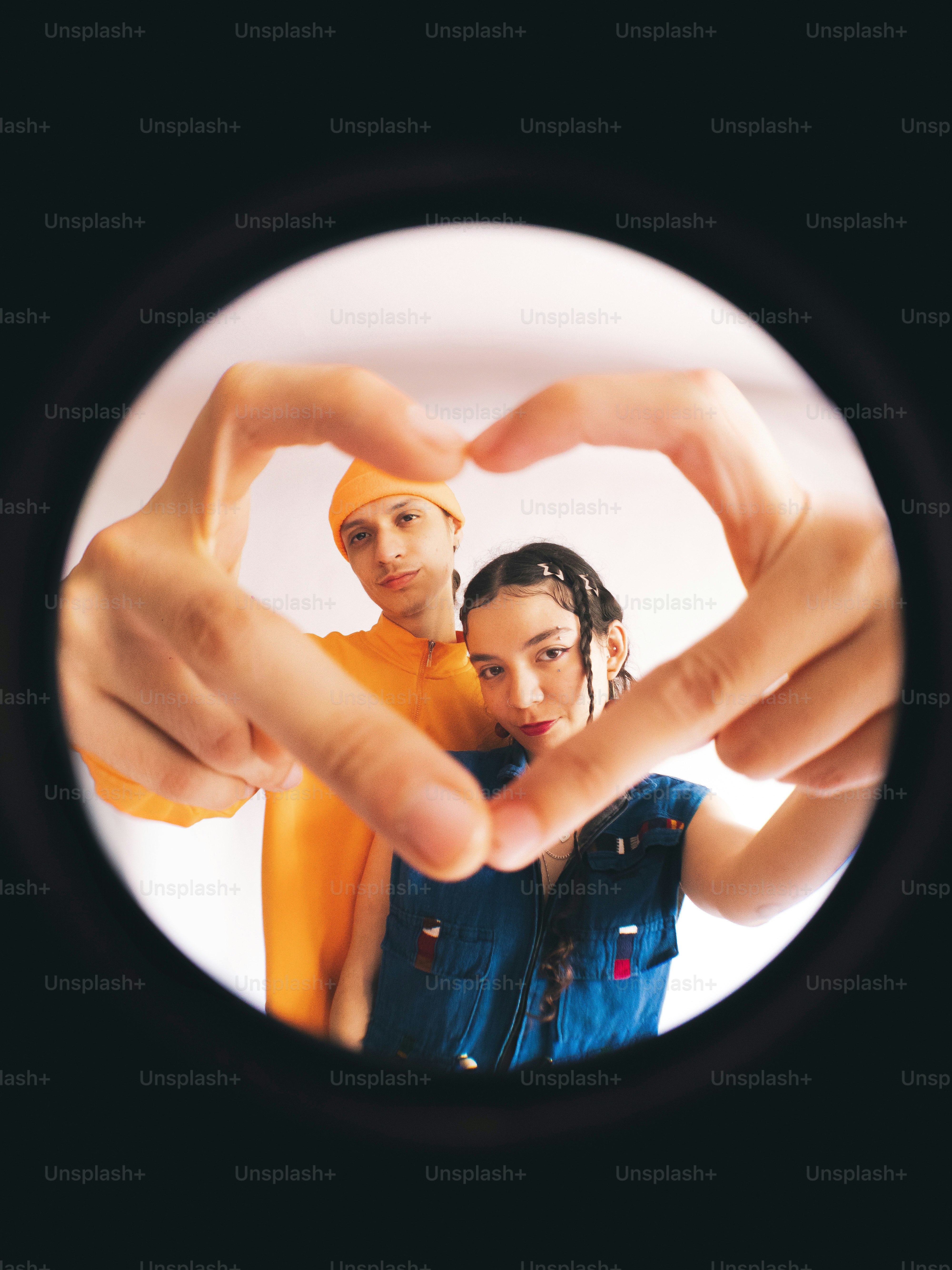 A man and woman making a heart shape with their hands photo – Trend ...