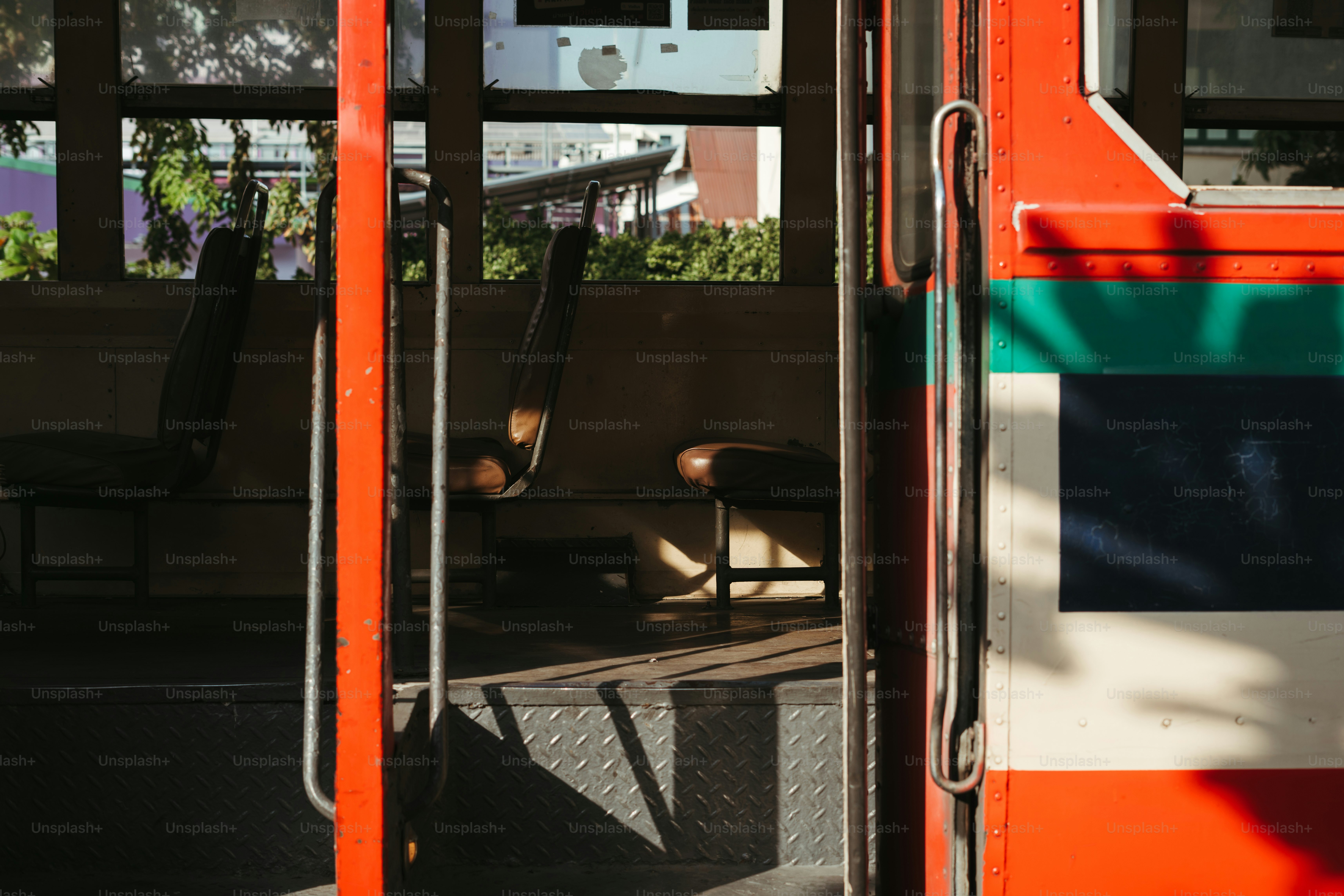 An orange and white bus with its door open