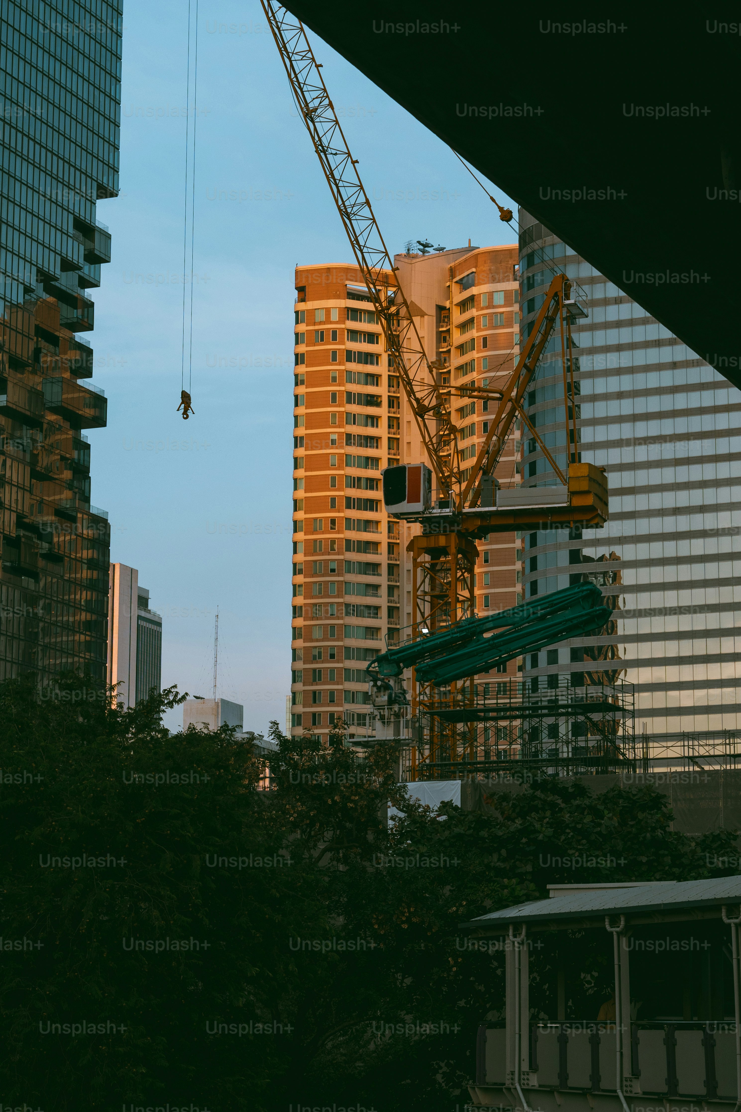 A view of a city with a crane in the background