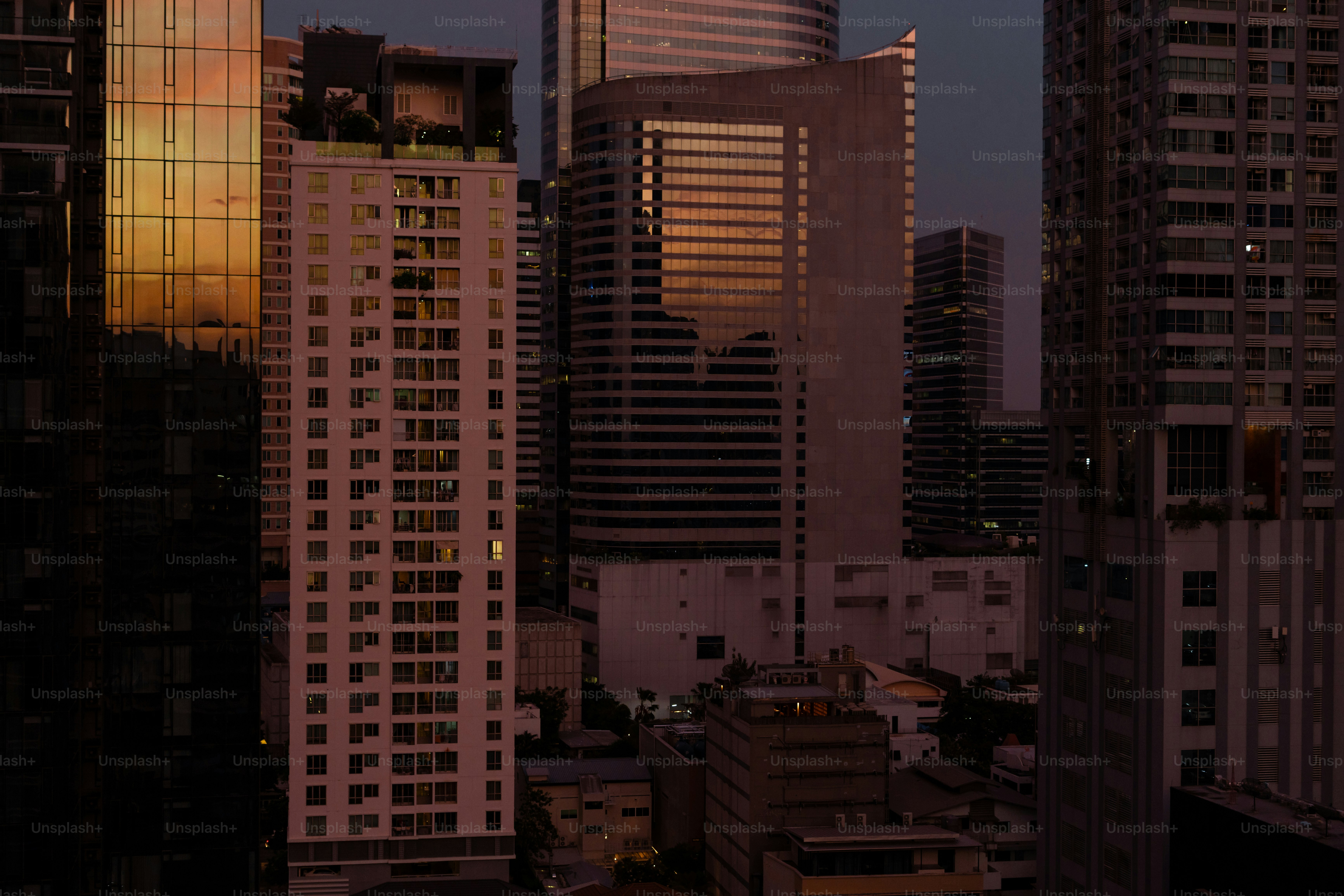 A view of a city at night with tall buildings