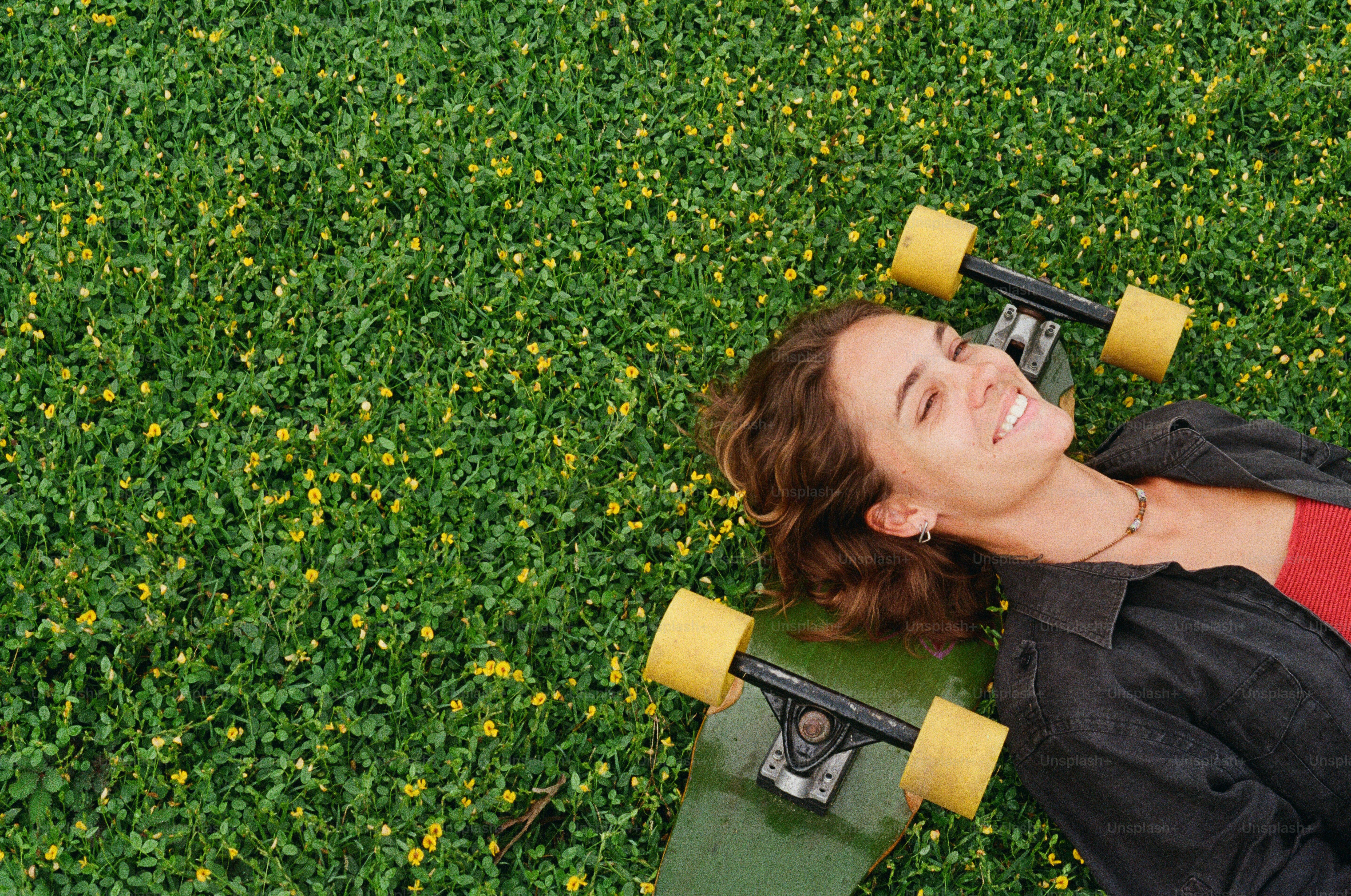 A man laying on the ground with a skateboard
