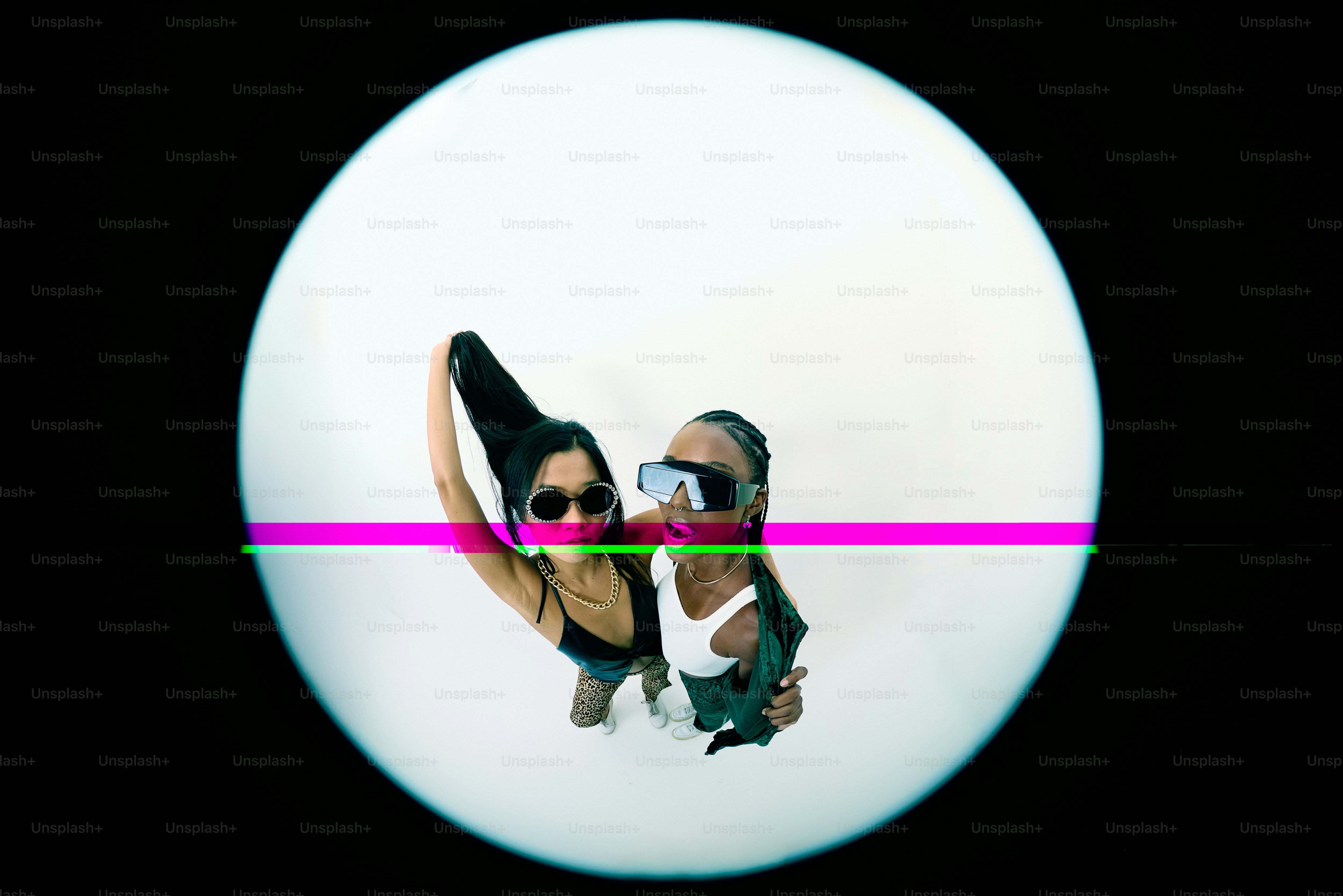 A woman wearing sunglasses and a tank top standing in front of a white circle