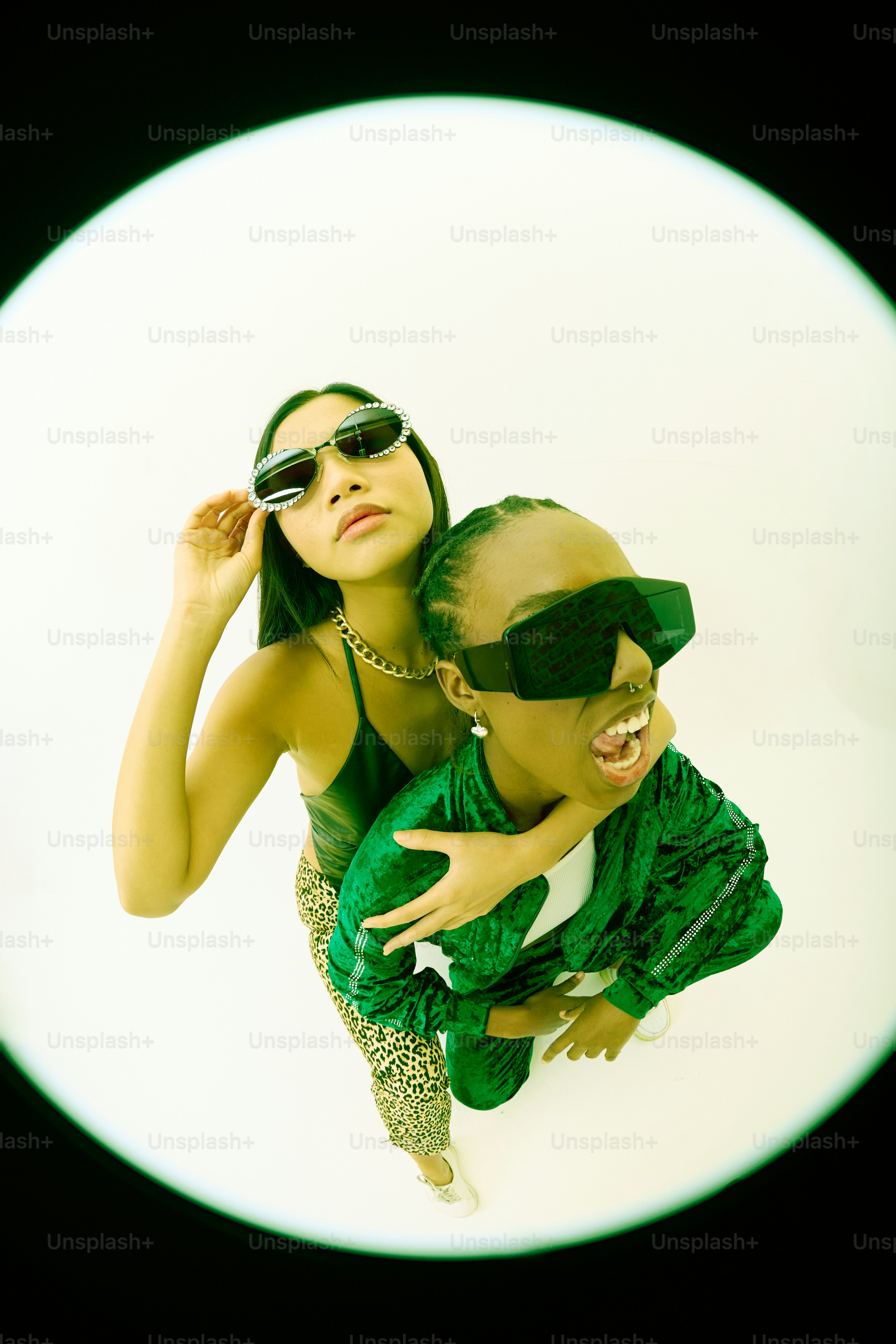 A woman in a green dress and a man in a green suit