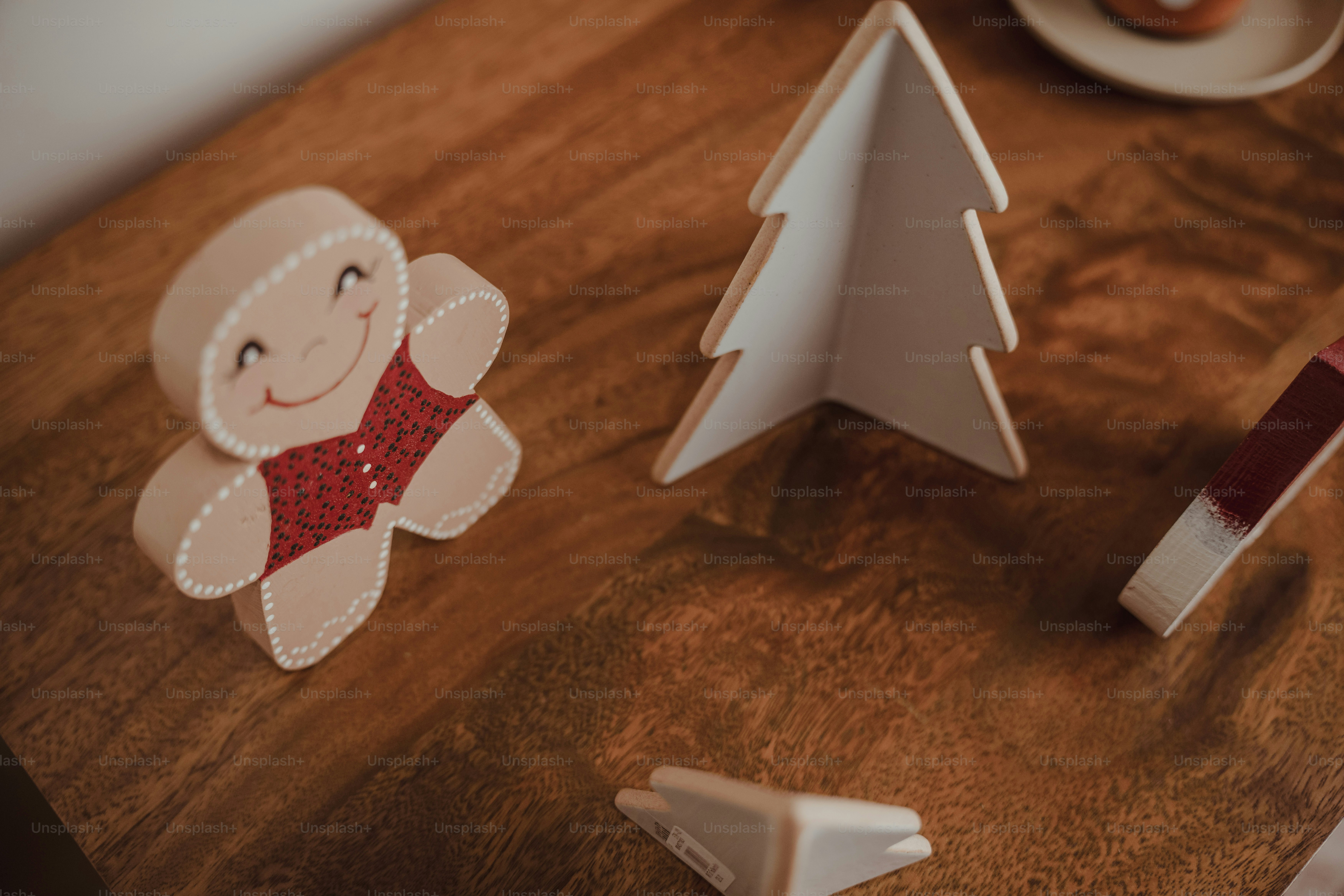 A wooden table topped with paper cut outs