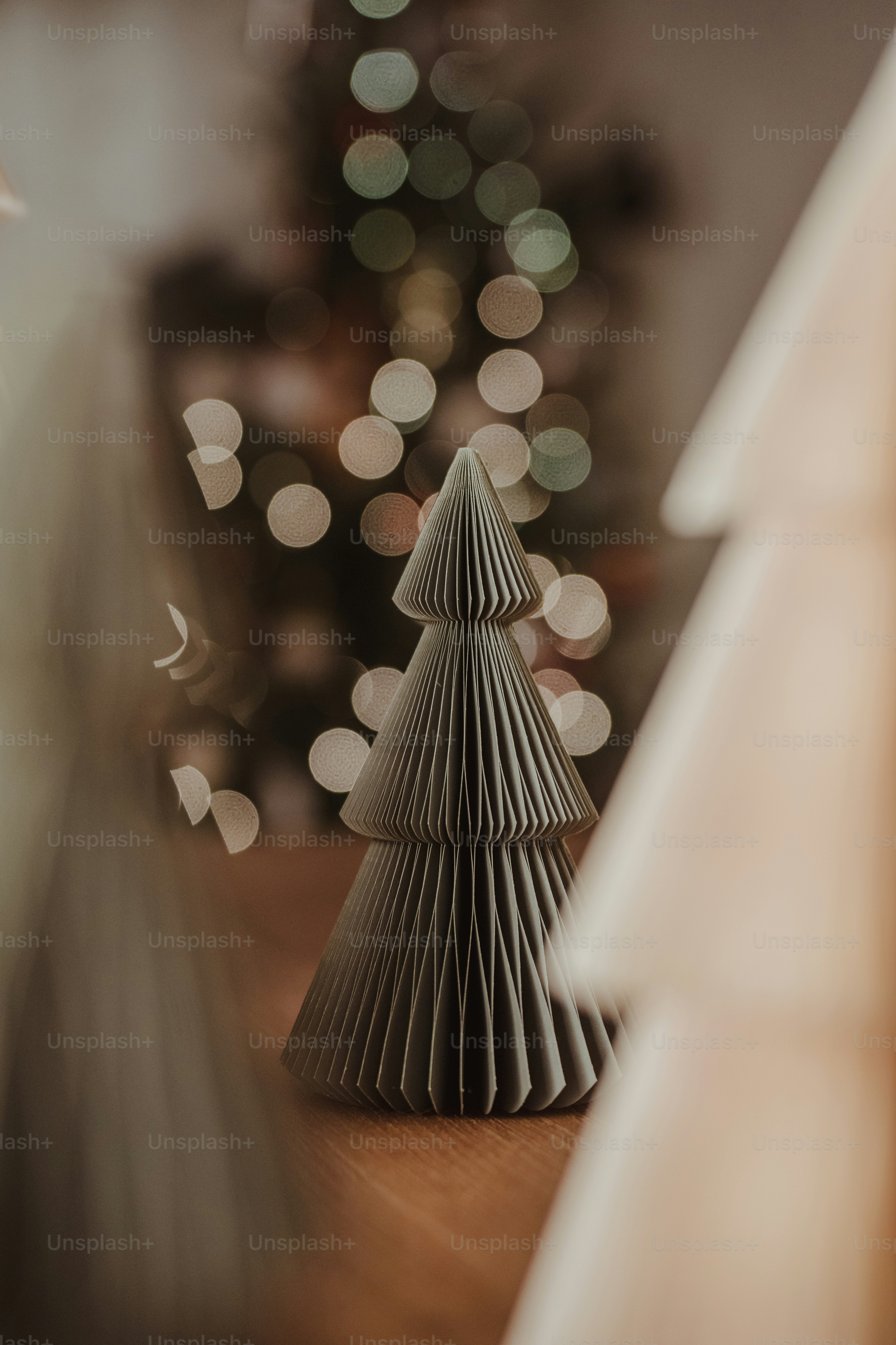 A paper christmas tree sitting on top of a wooden table