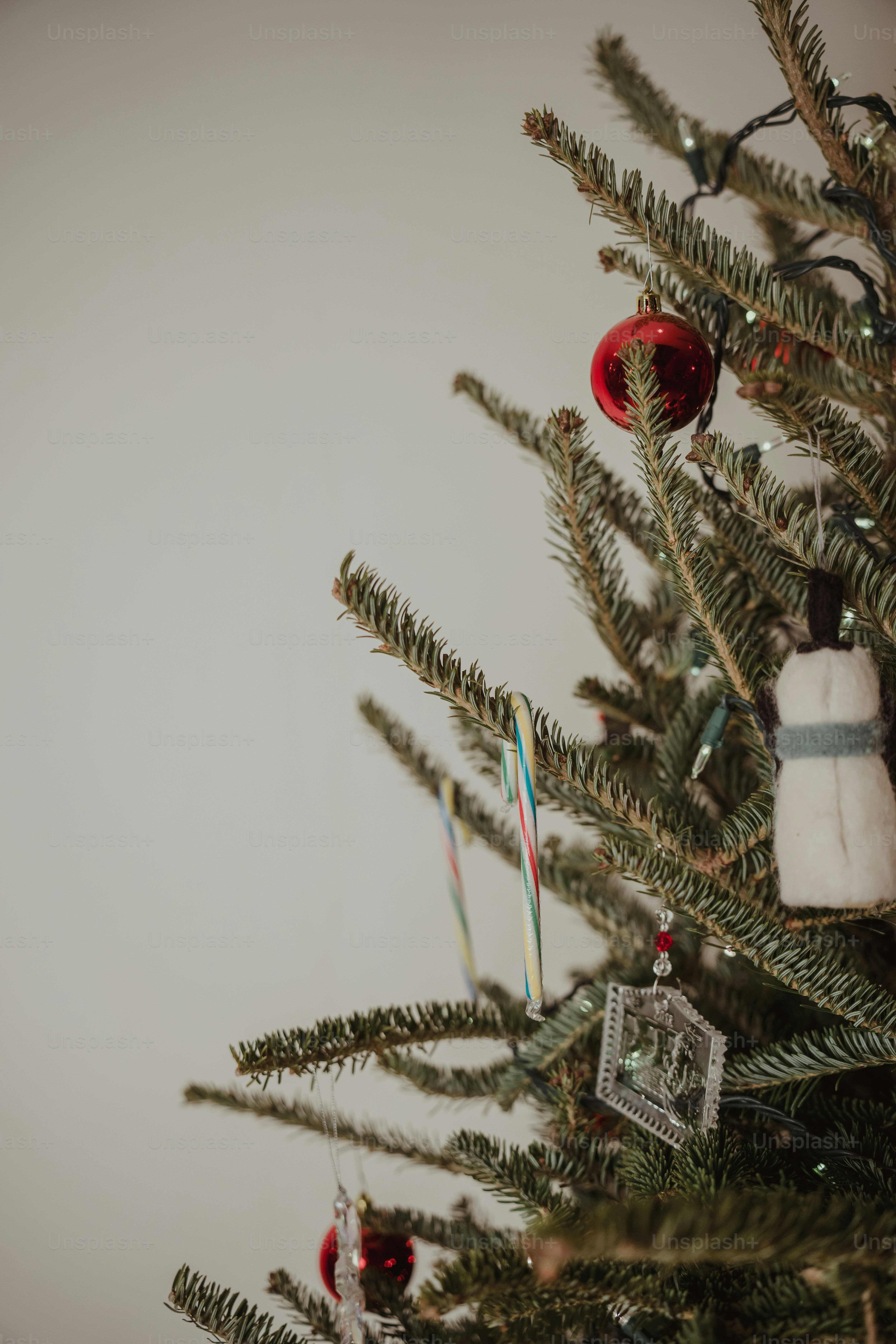 A close up of a christmas tree with ornaments on it