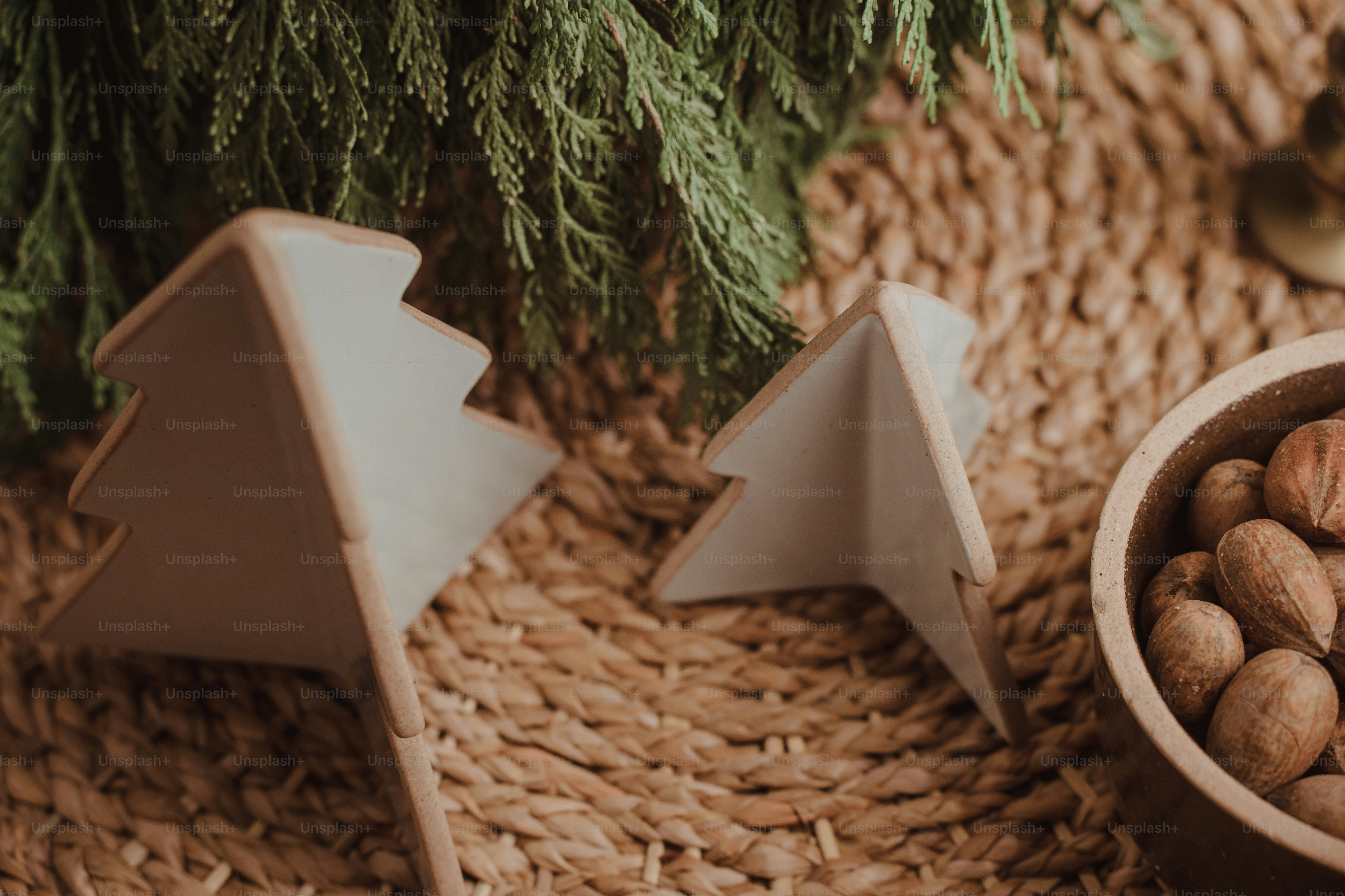 A bowl of nuts sitting next to a wooden ornament