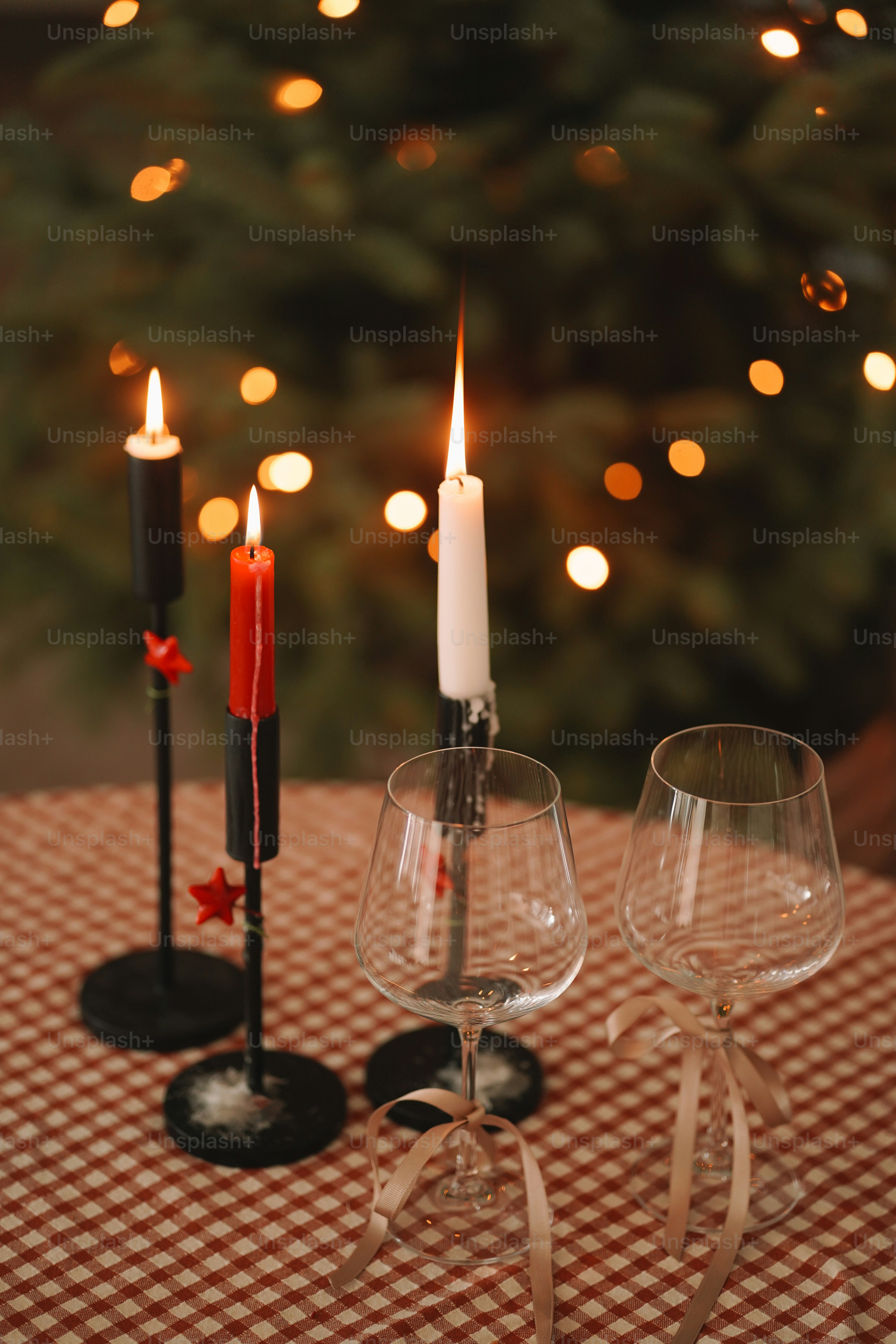 A table topped with two wine glasses and a candle