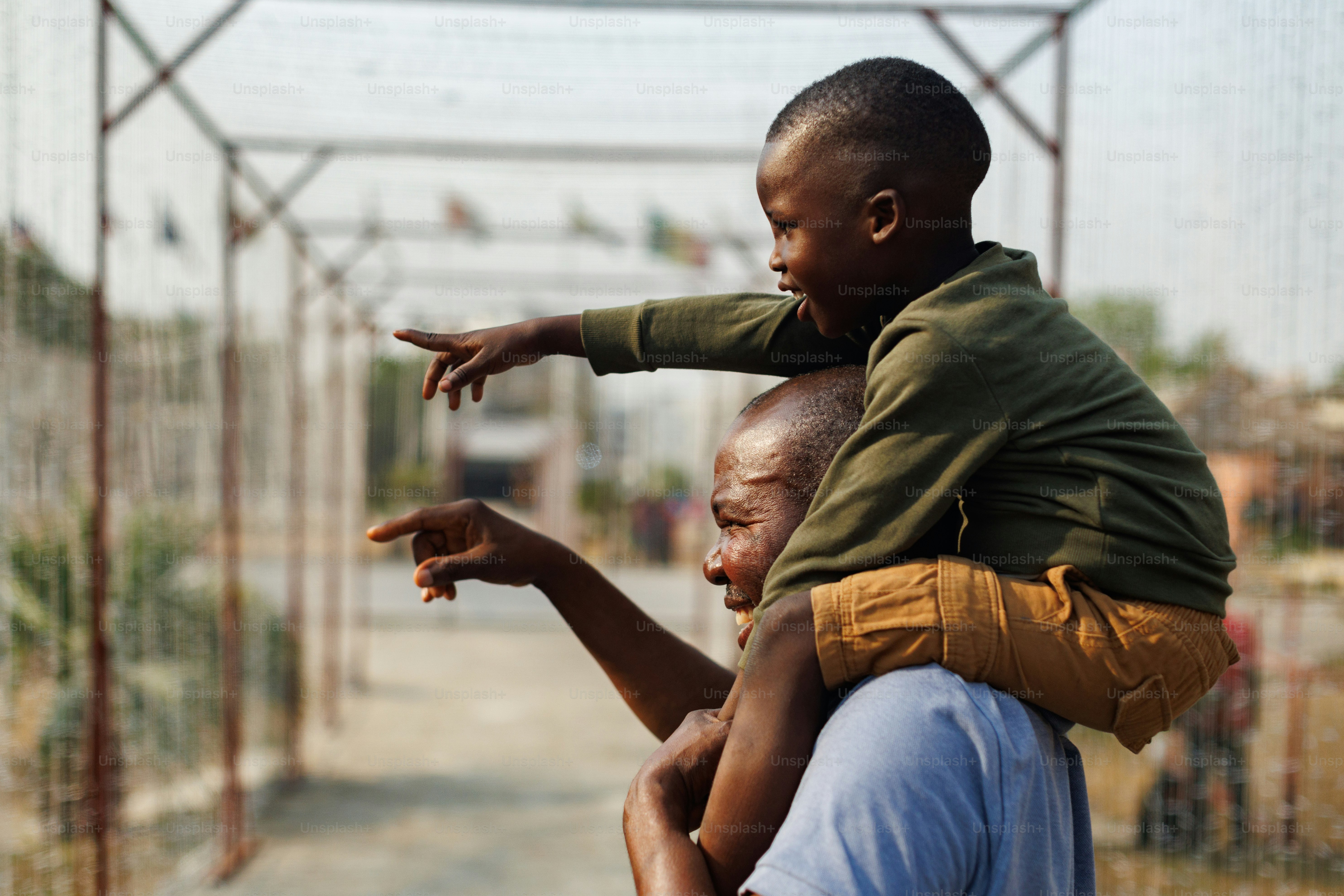 A man holding a child on his back