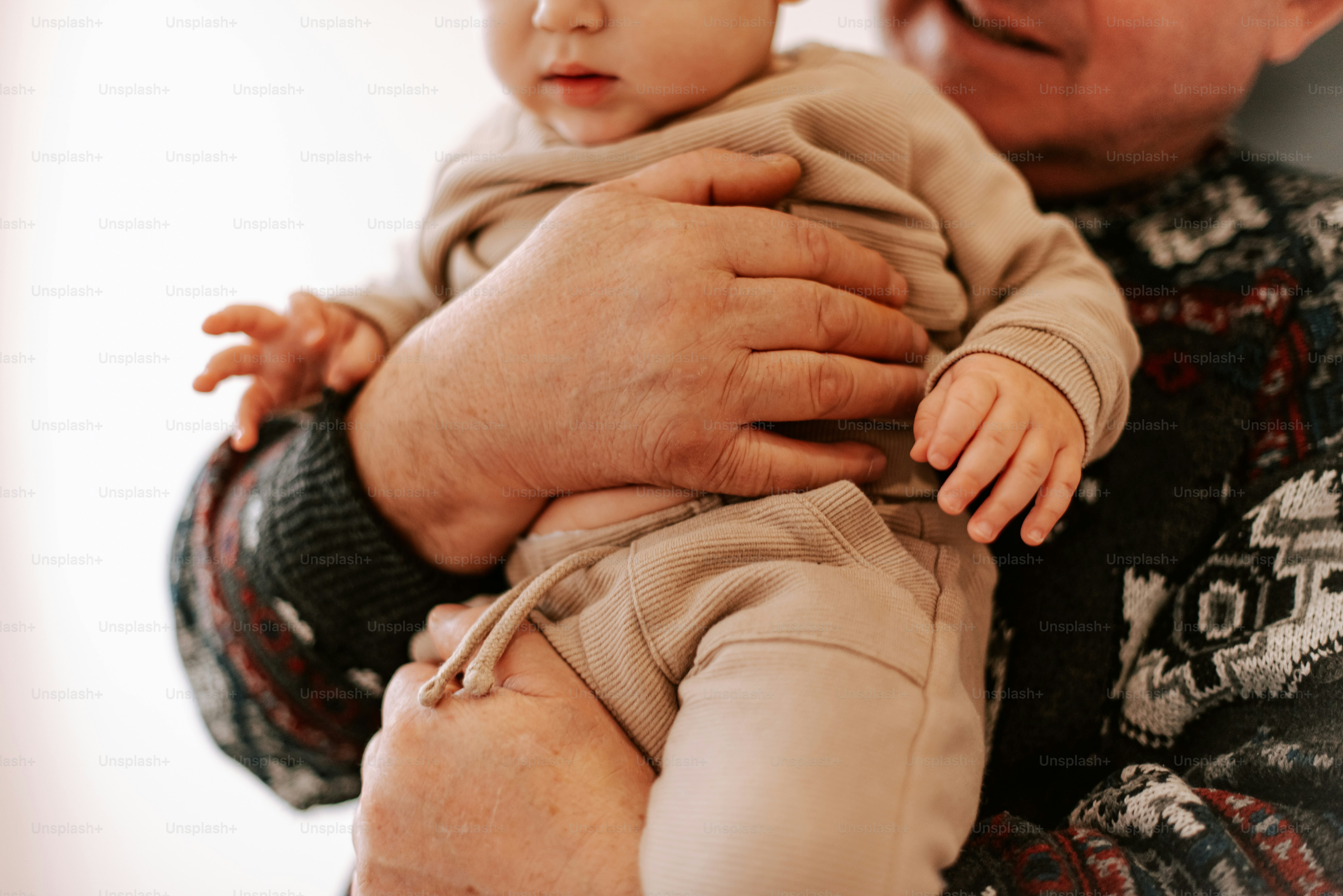 A man holding a baby in his arms