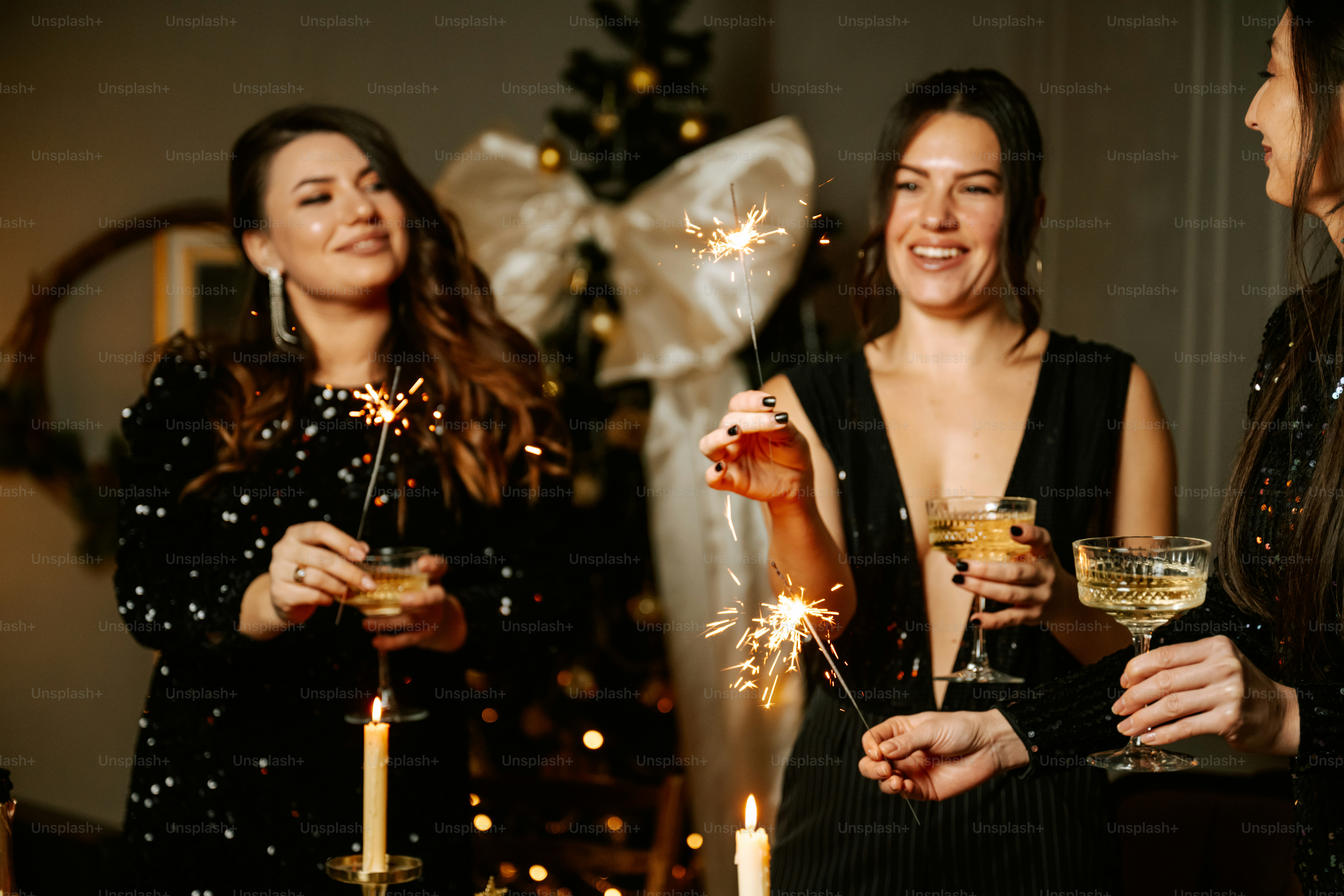 A group of women standing next to each other holding wine glasses photo ...