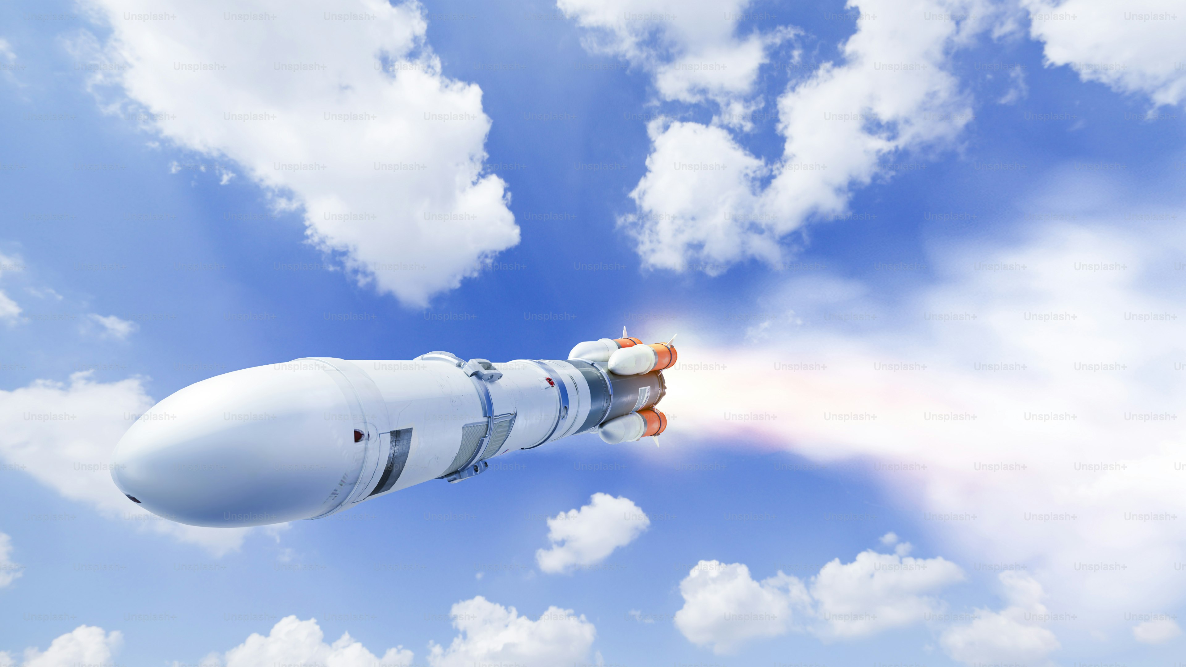 A large white object flying through a blue cloudy sky photo ...