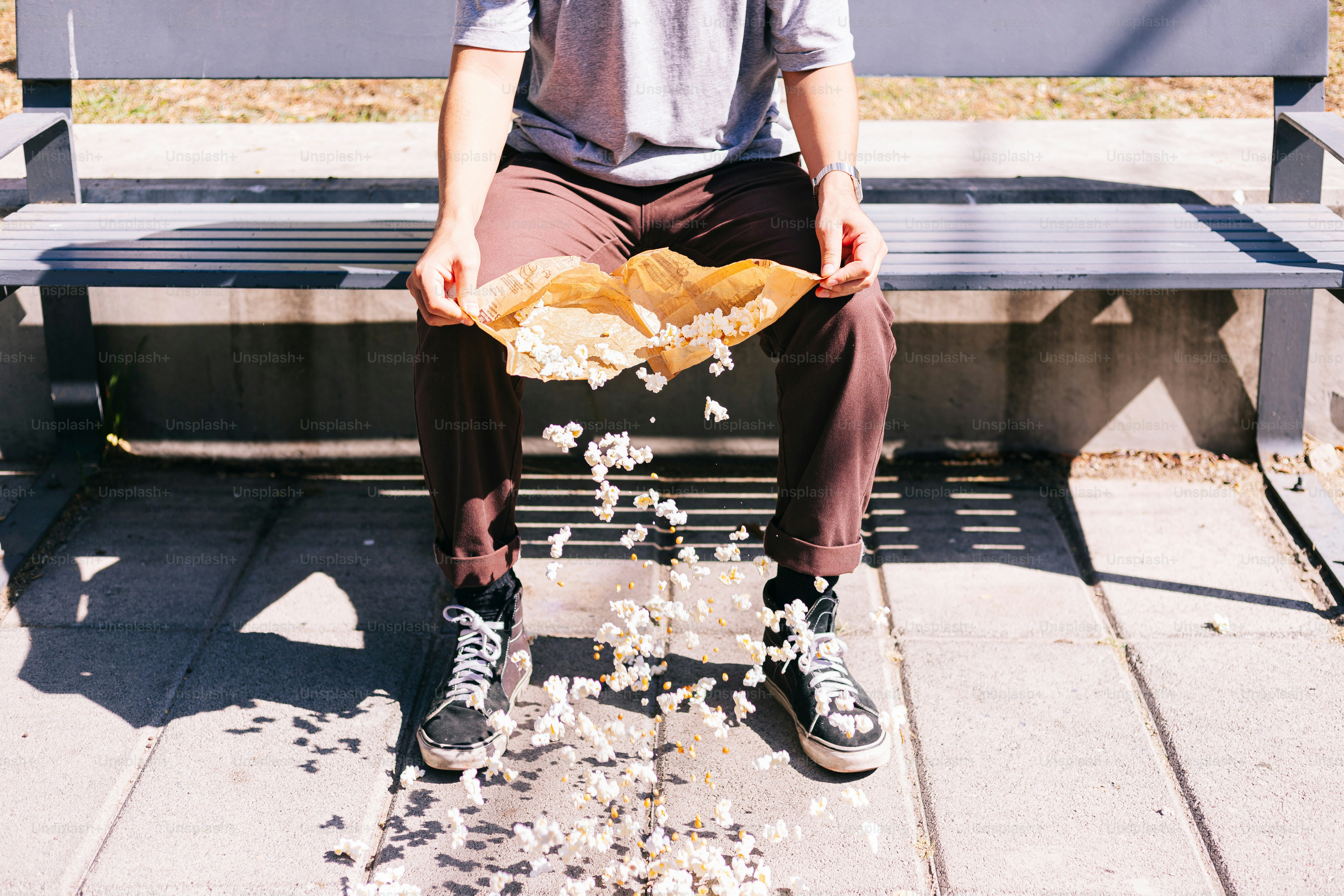 A man sitting on a bench with a plate of food