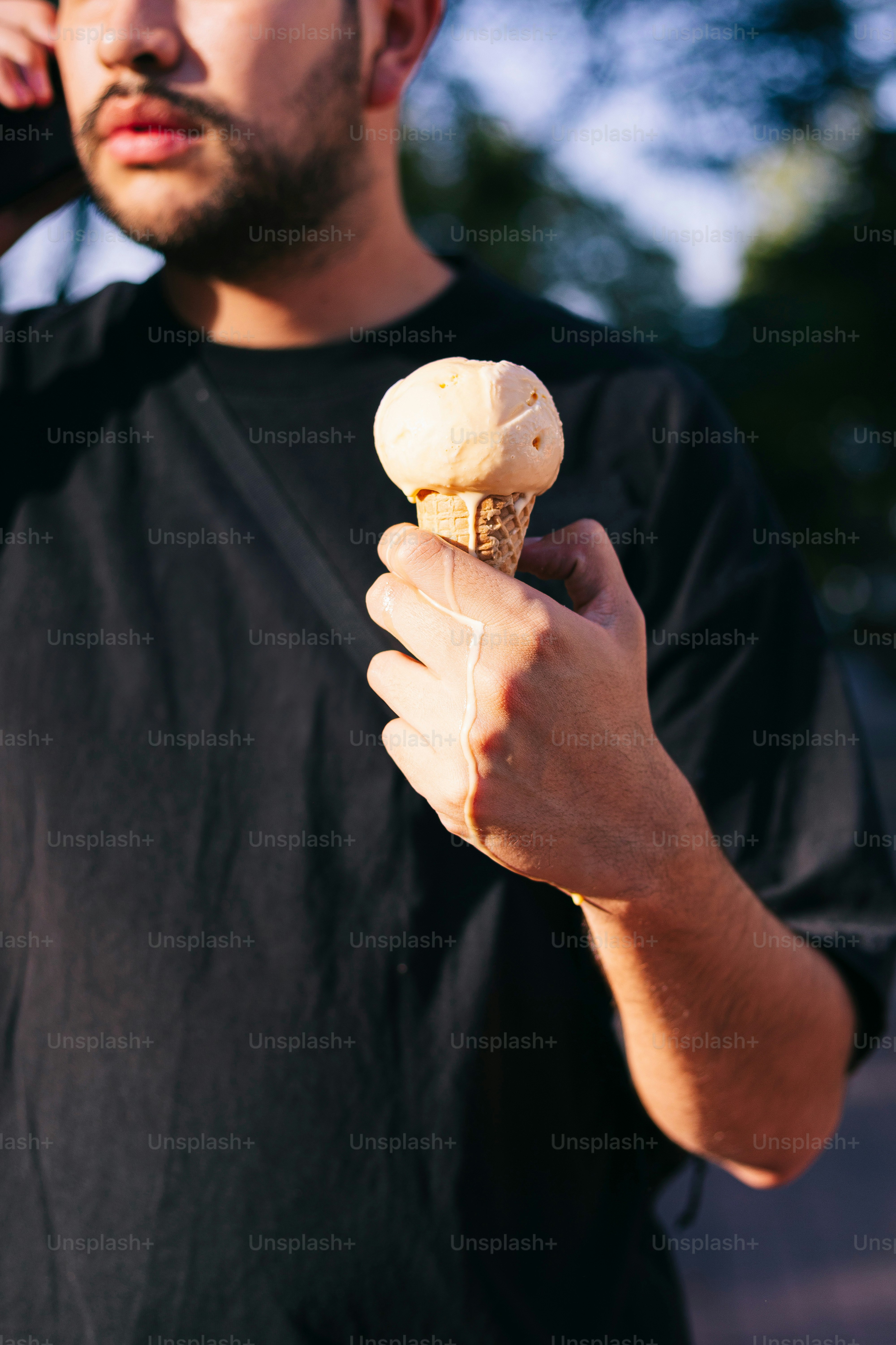 A man talking on a cell phone while holding a banana