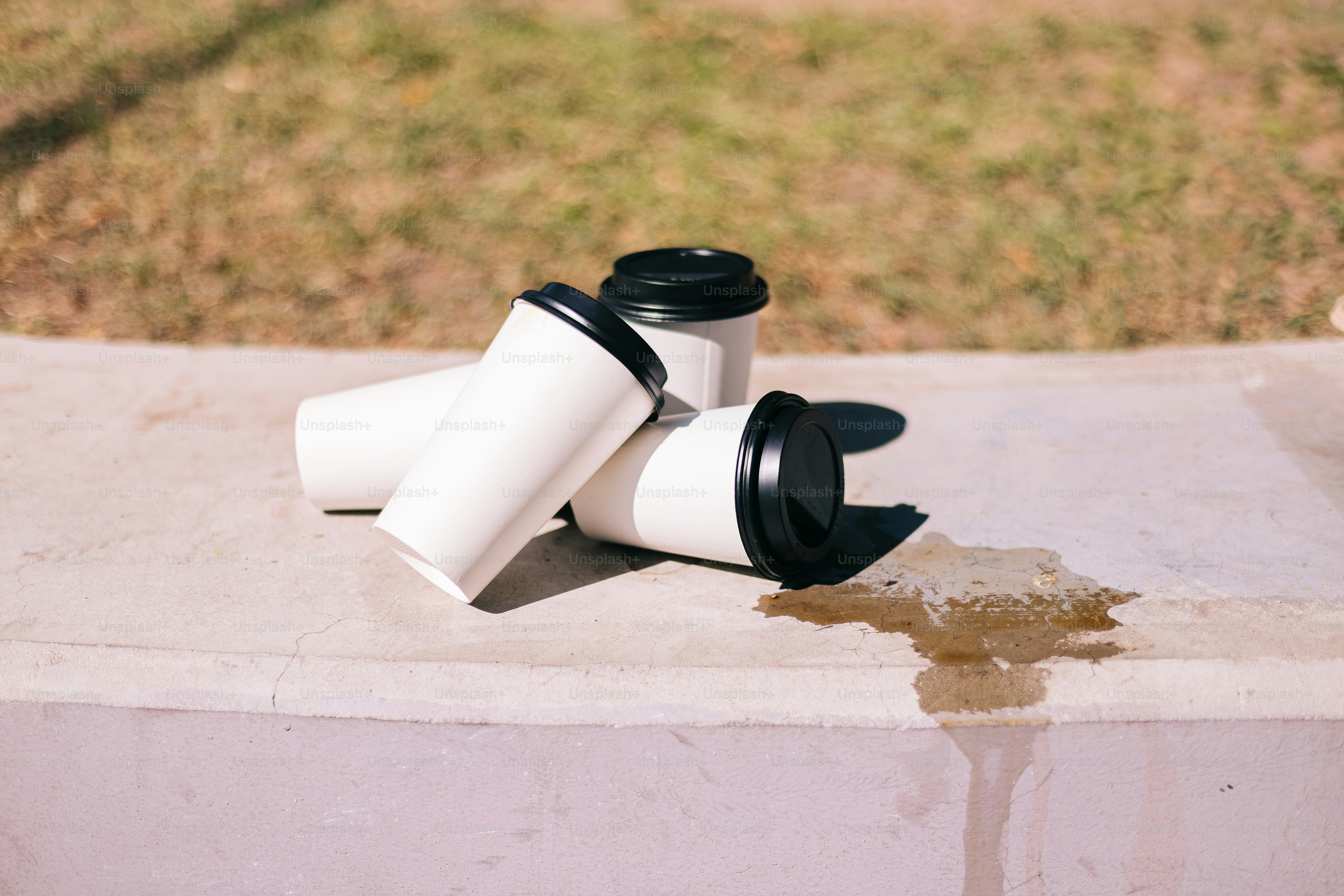 A couple of cups sitting on top of a cement block photo – Playful Image ...