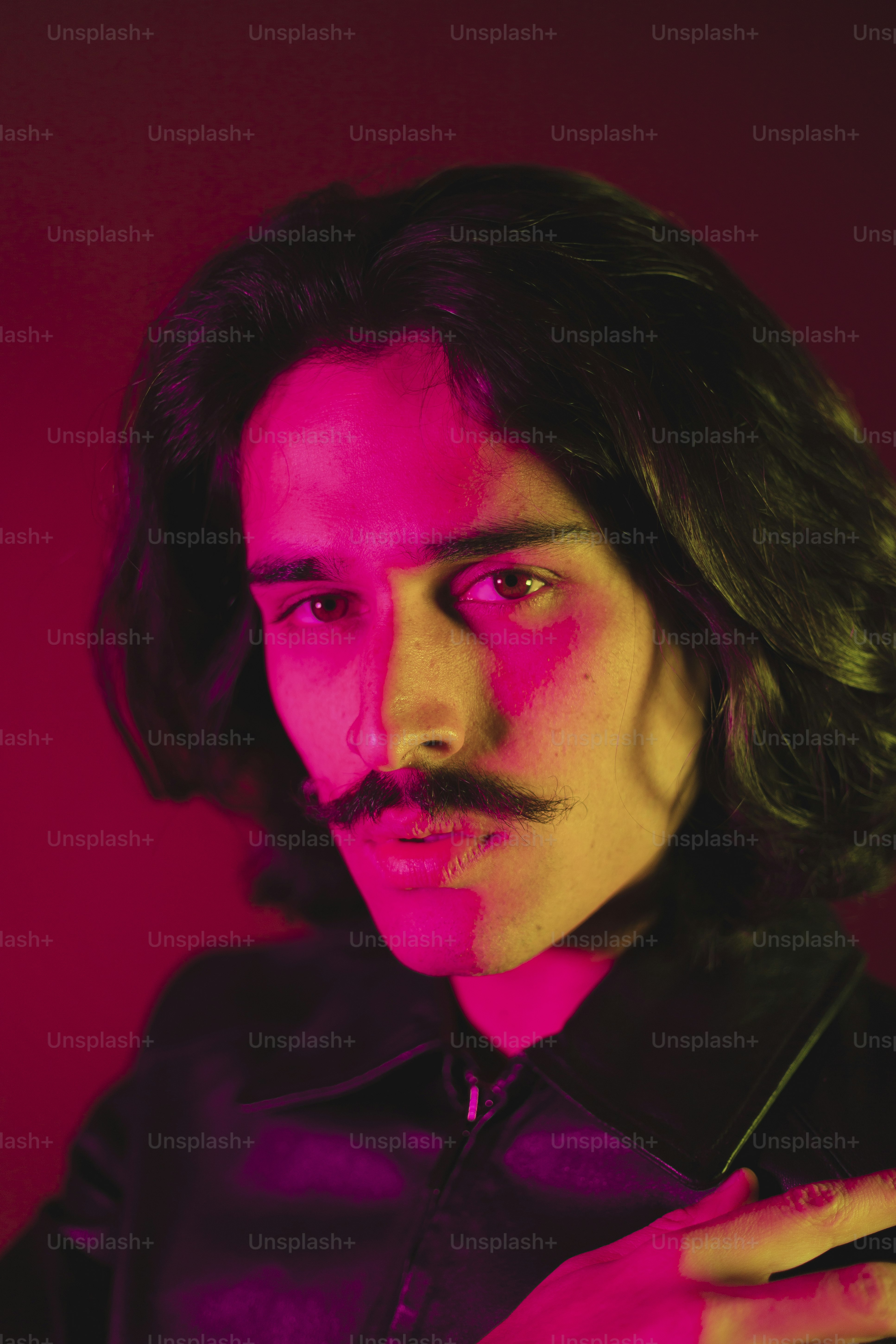 A man with long hair and a moustache
