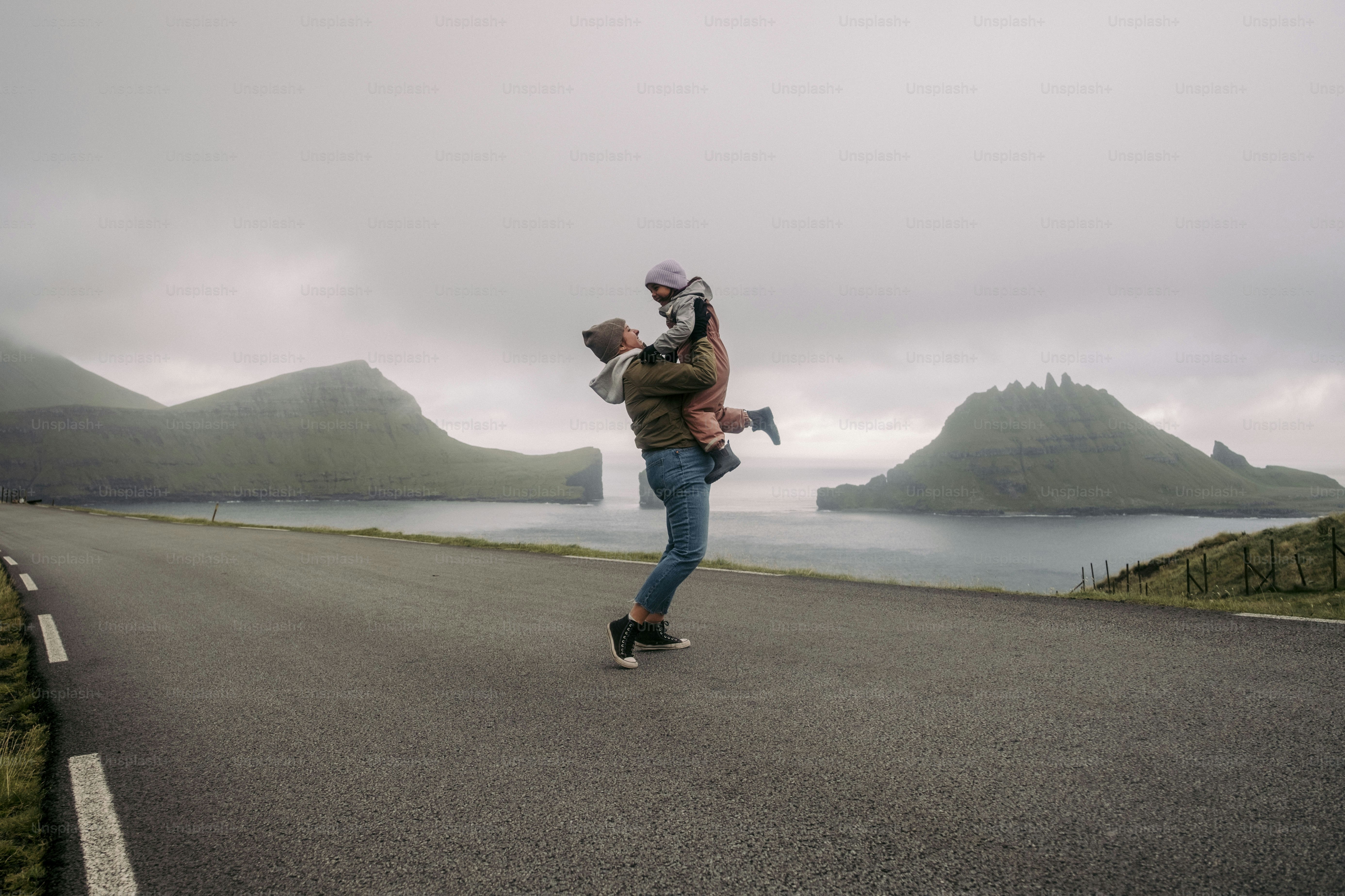A man riding a skateboard down the middle of a road