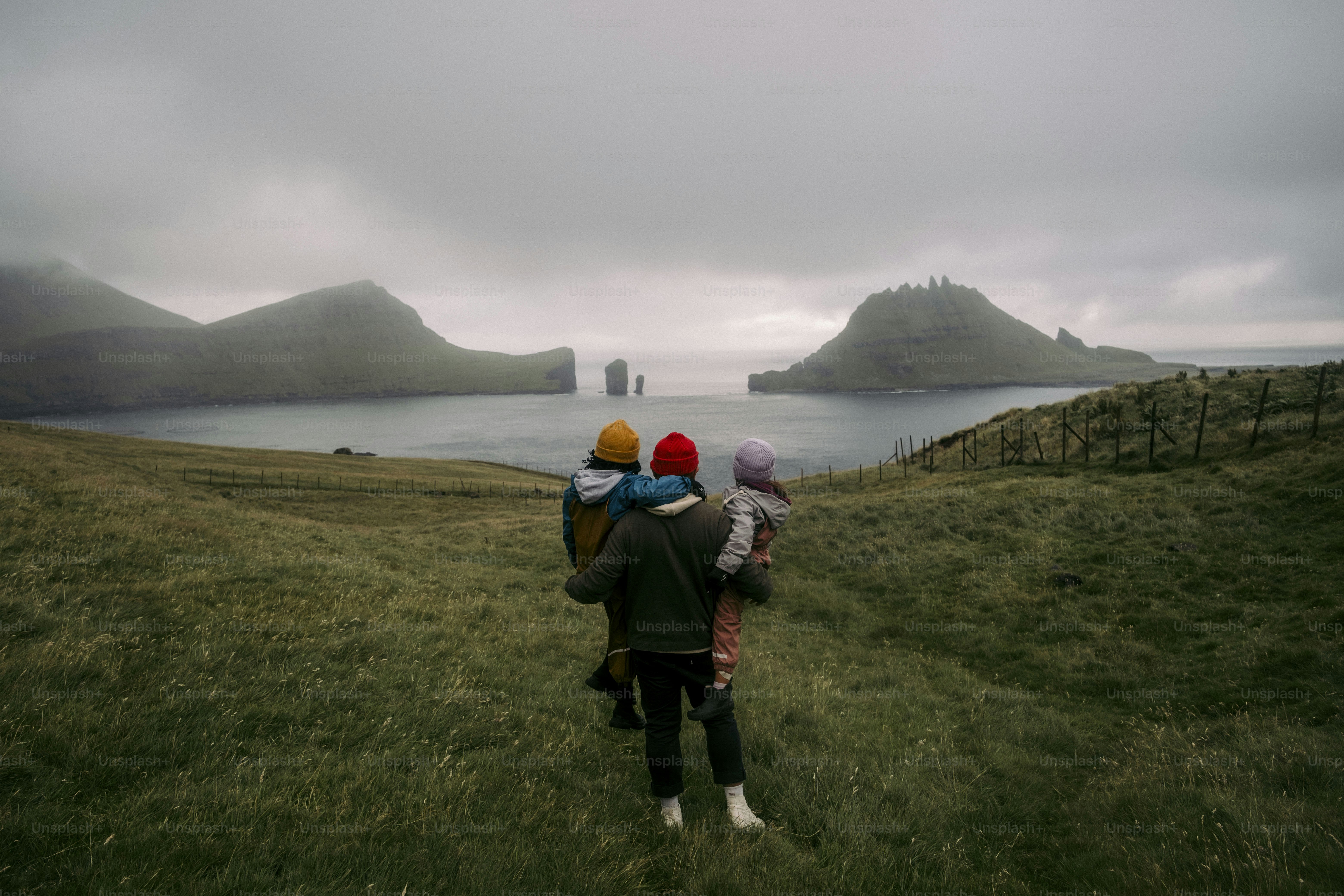 A couple of people that are standing in the grass