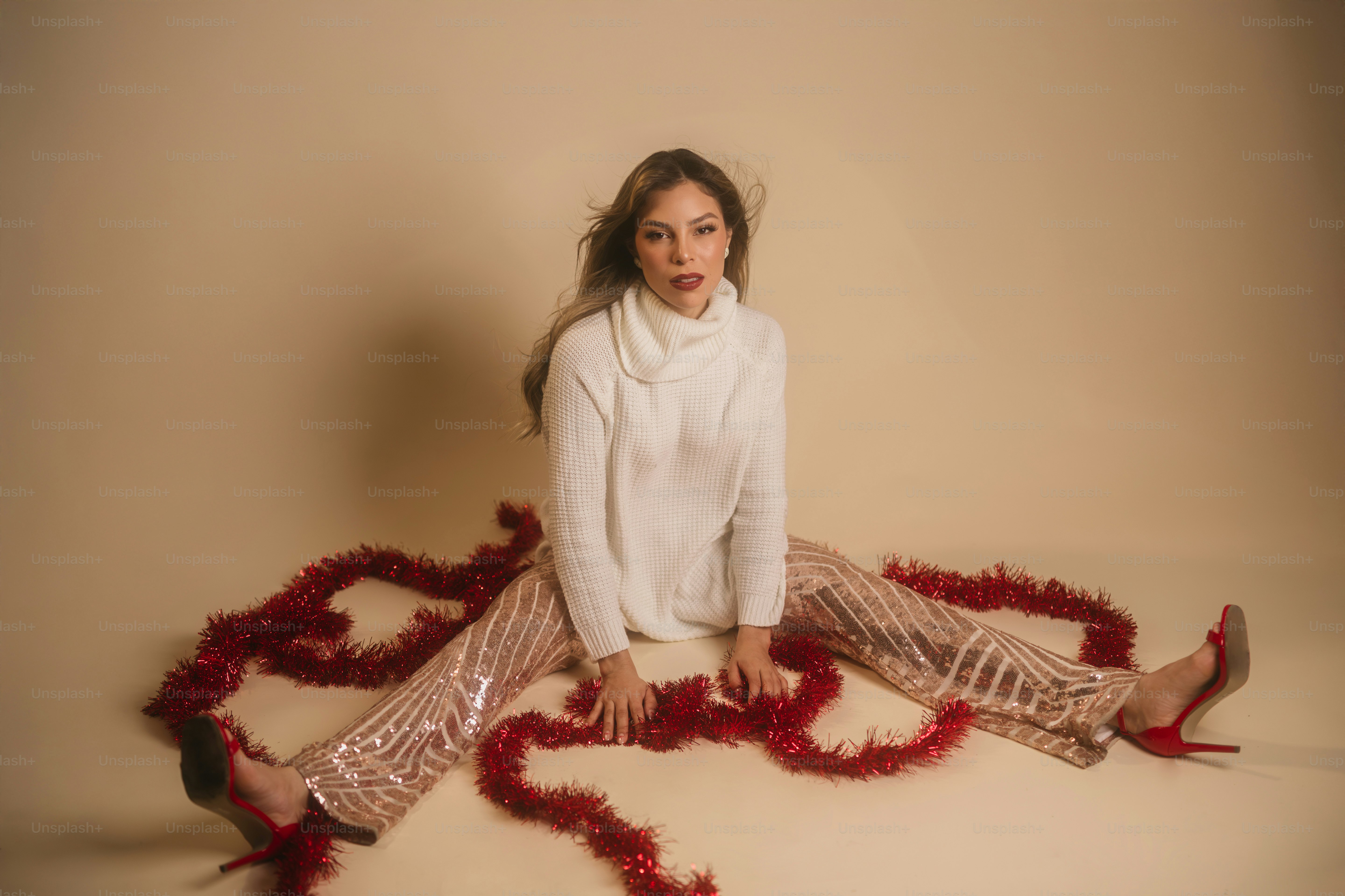 A woman sitting on the floor with a heart shaped decoration