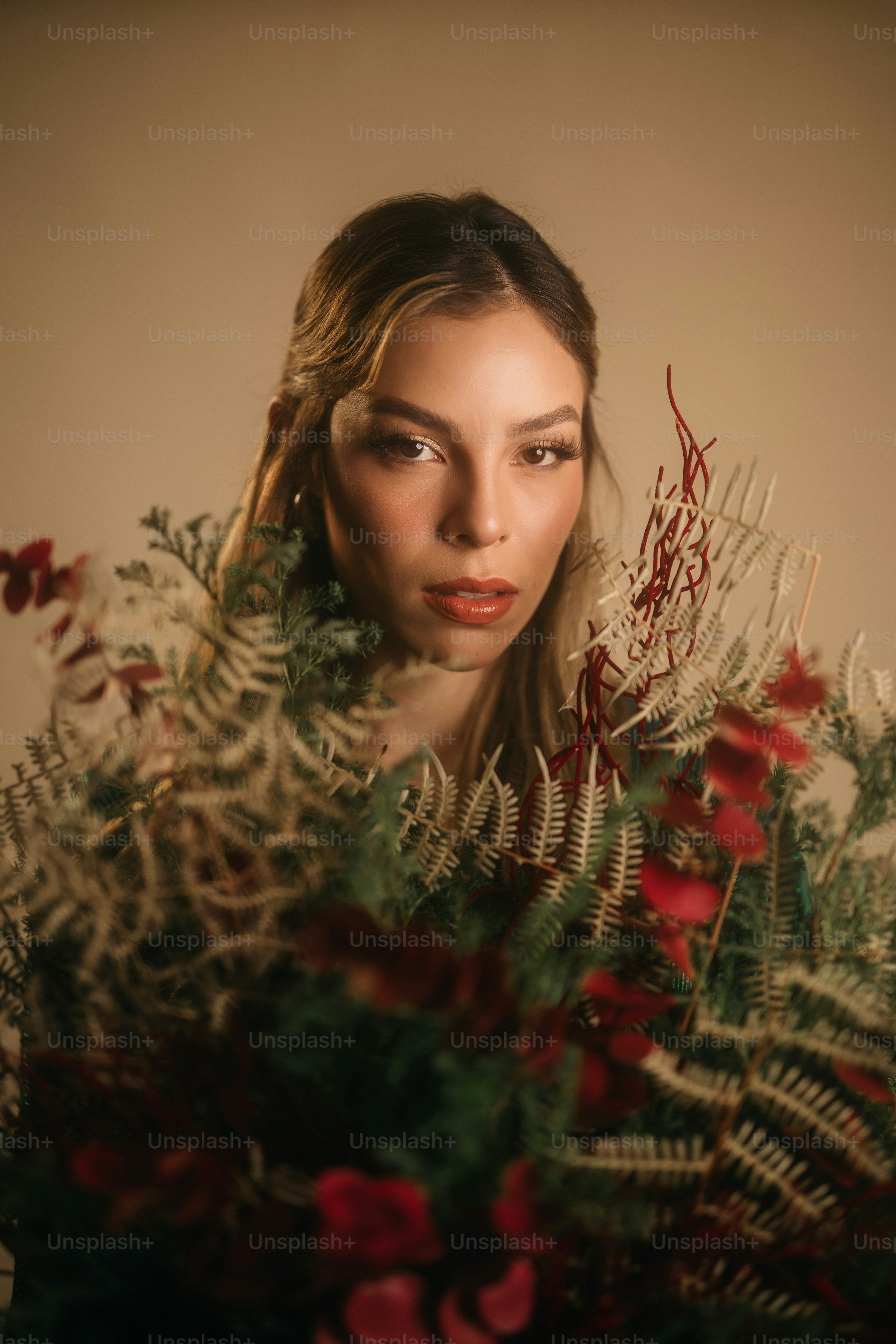 A woman holding a bouquet of flowers in front of her face