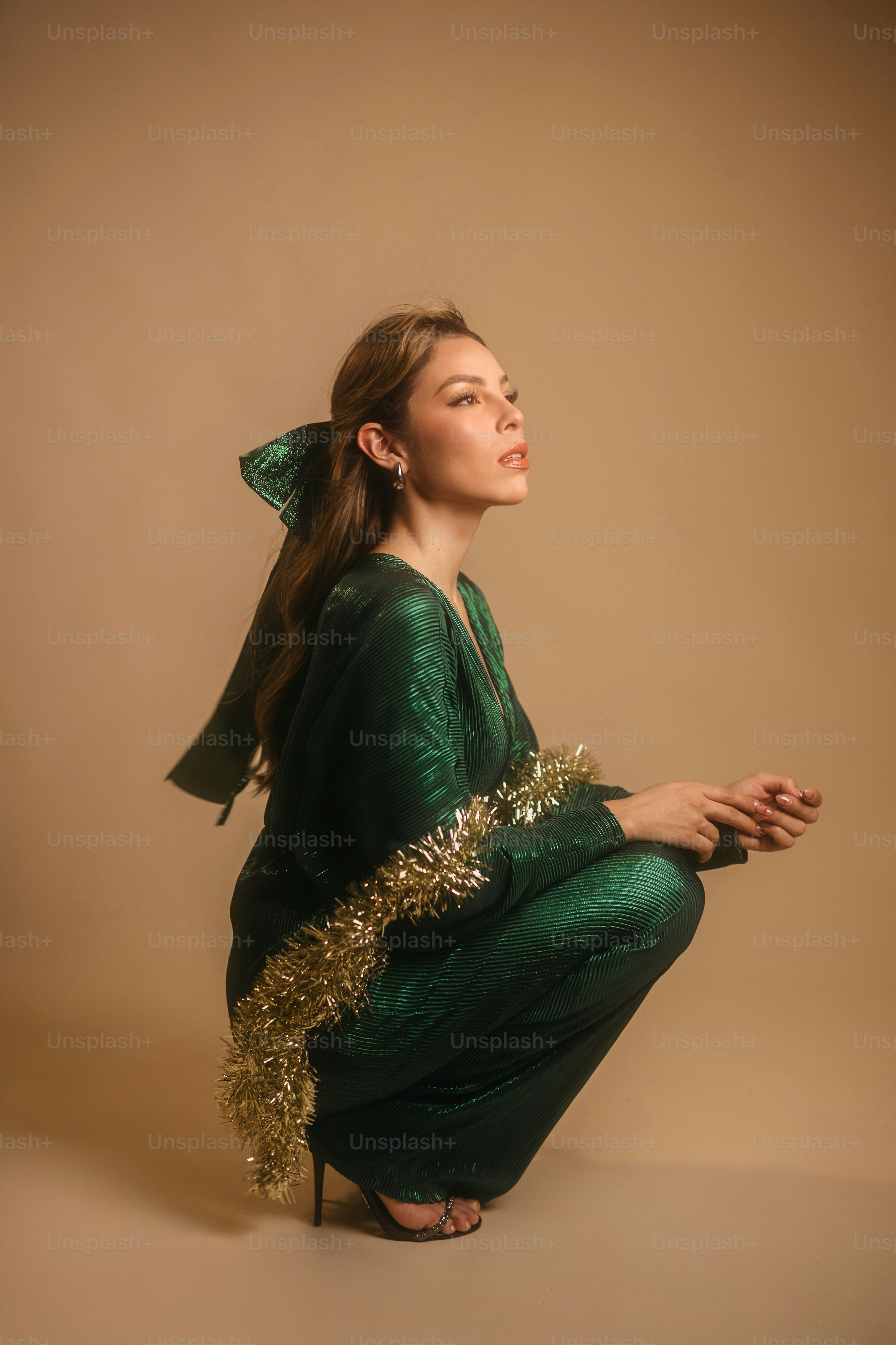A woman in a green dress sitting on the ground