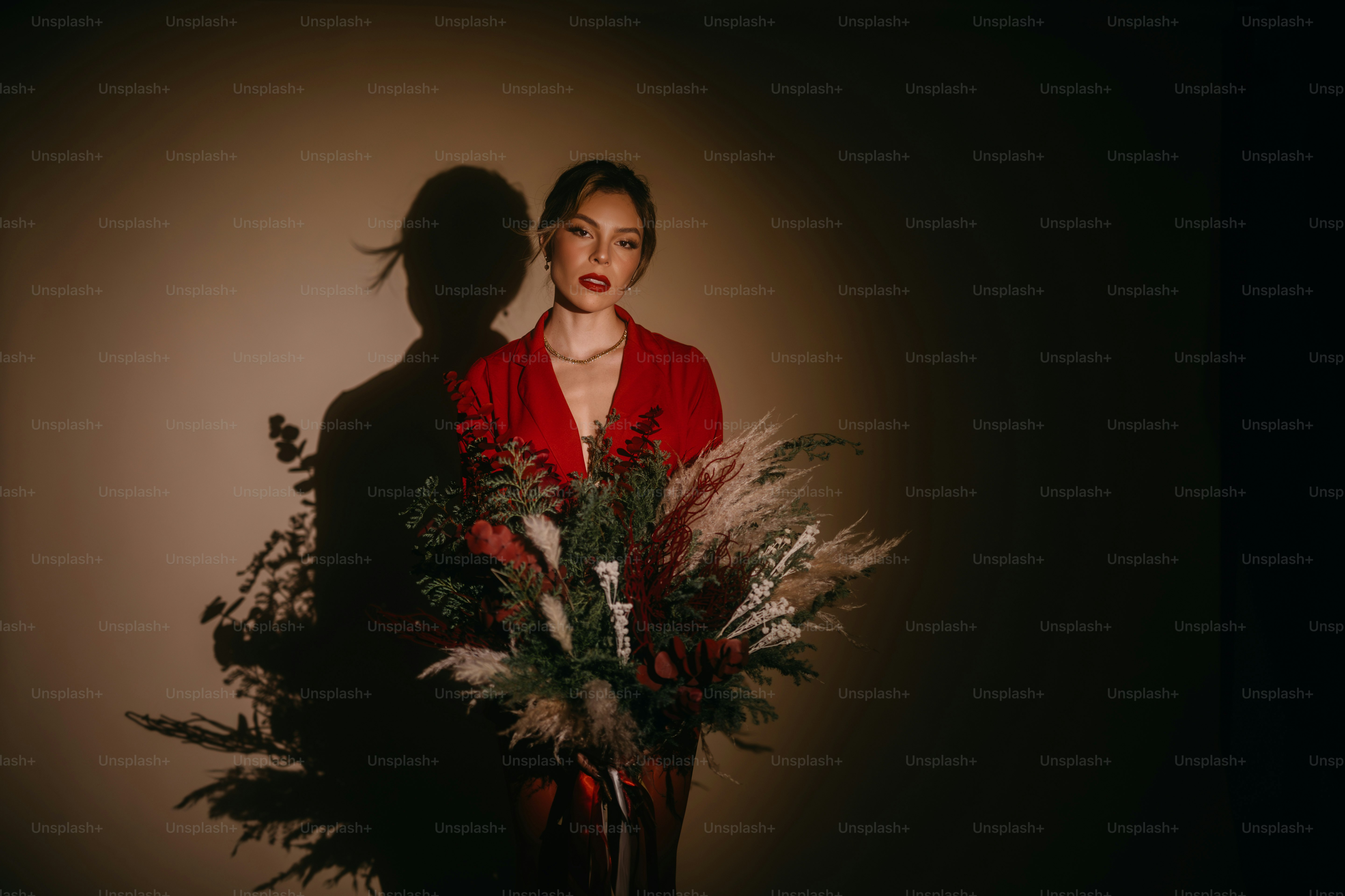 Una mujer de pie junto a un jarrón lleno de flores