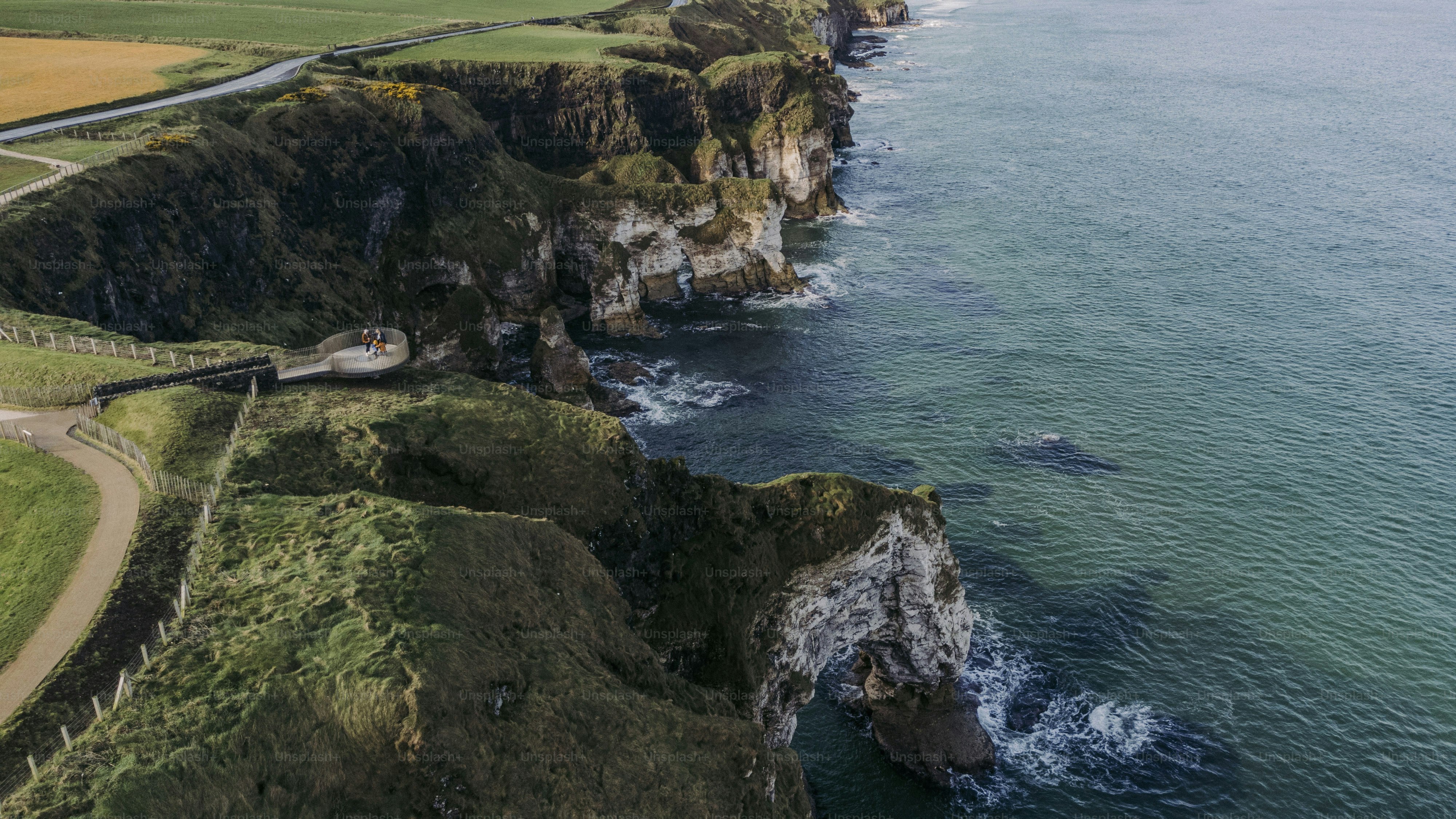 An aerial view of the ocean and a road